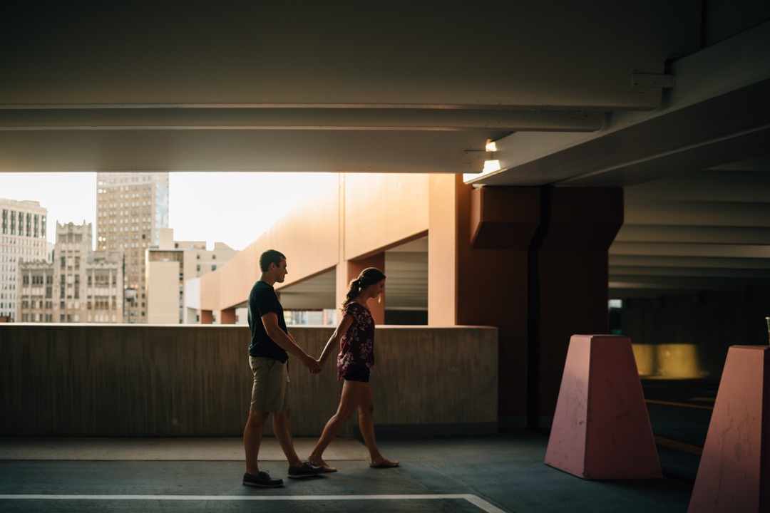 Man and woman walking during Detroit engagement session at the Z-deck parking garage