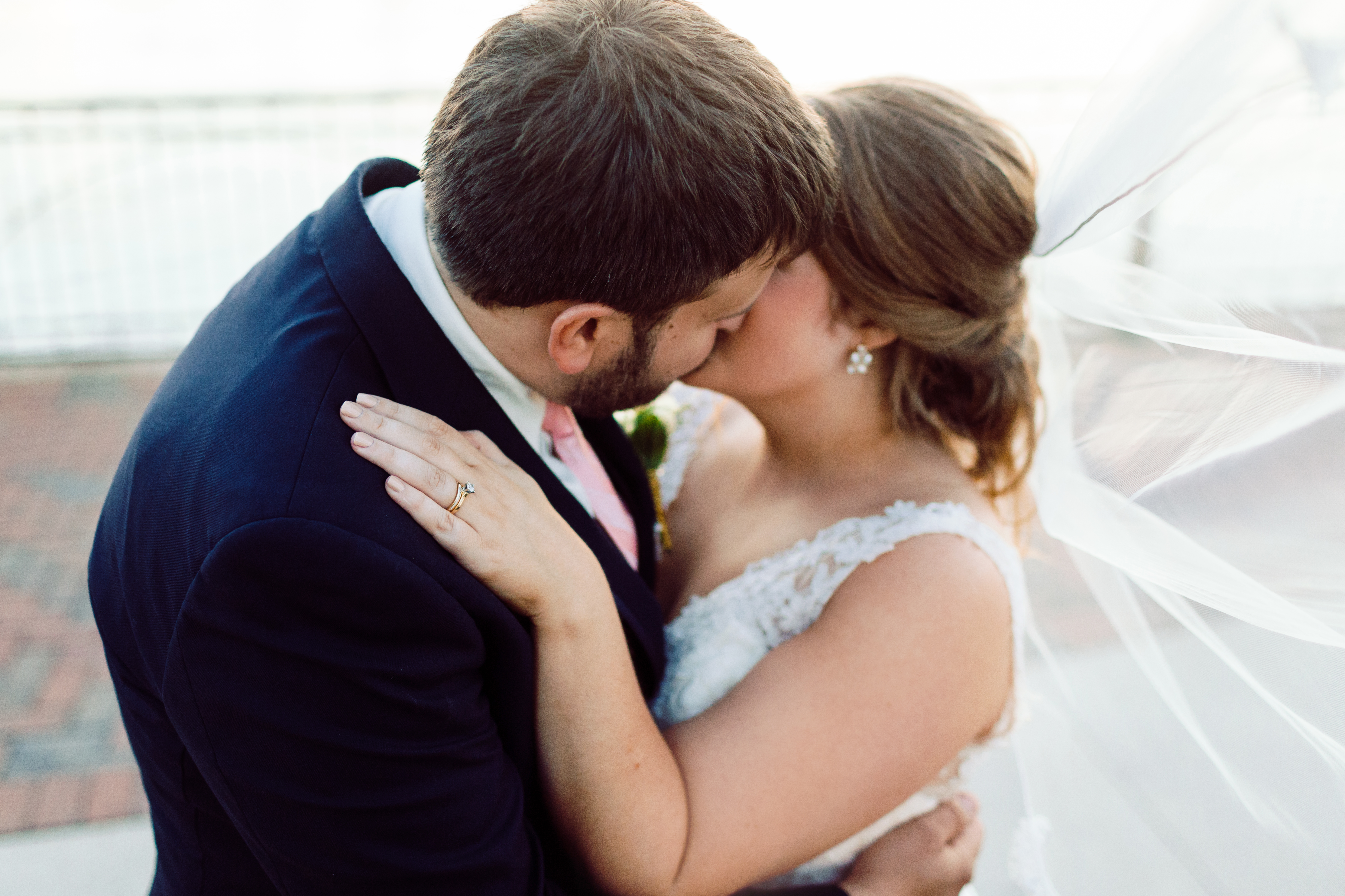 Bride and groom kissing on the waterfront in Bay City Double Tree