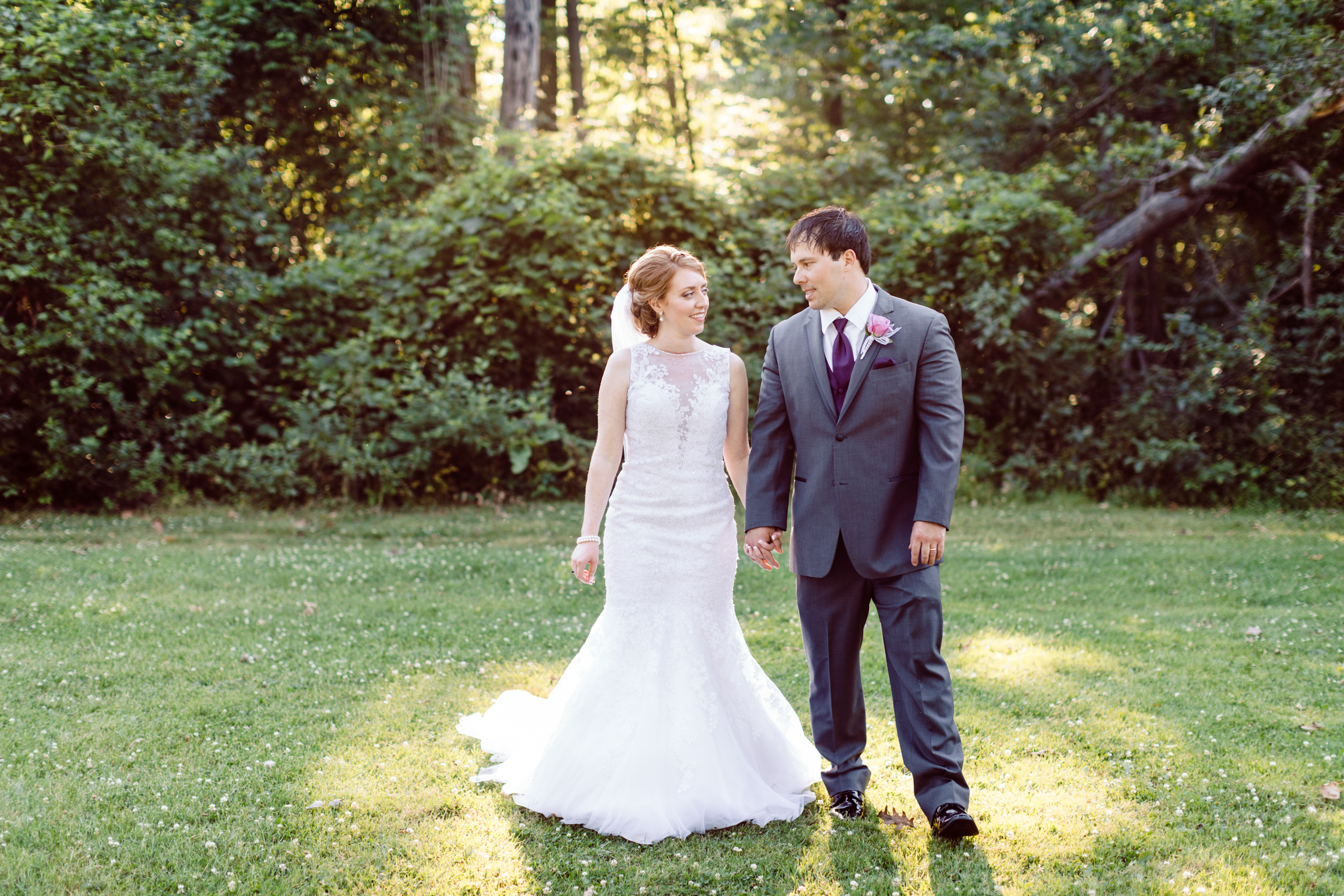 Bride and groom holding hands at Elizabeth Park in Trenton, Michigan
