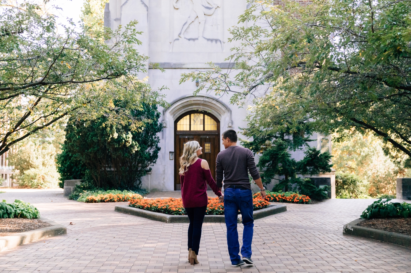 Couple walking towards Beaumont Tower holding hands