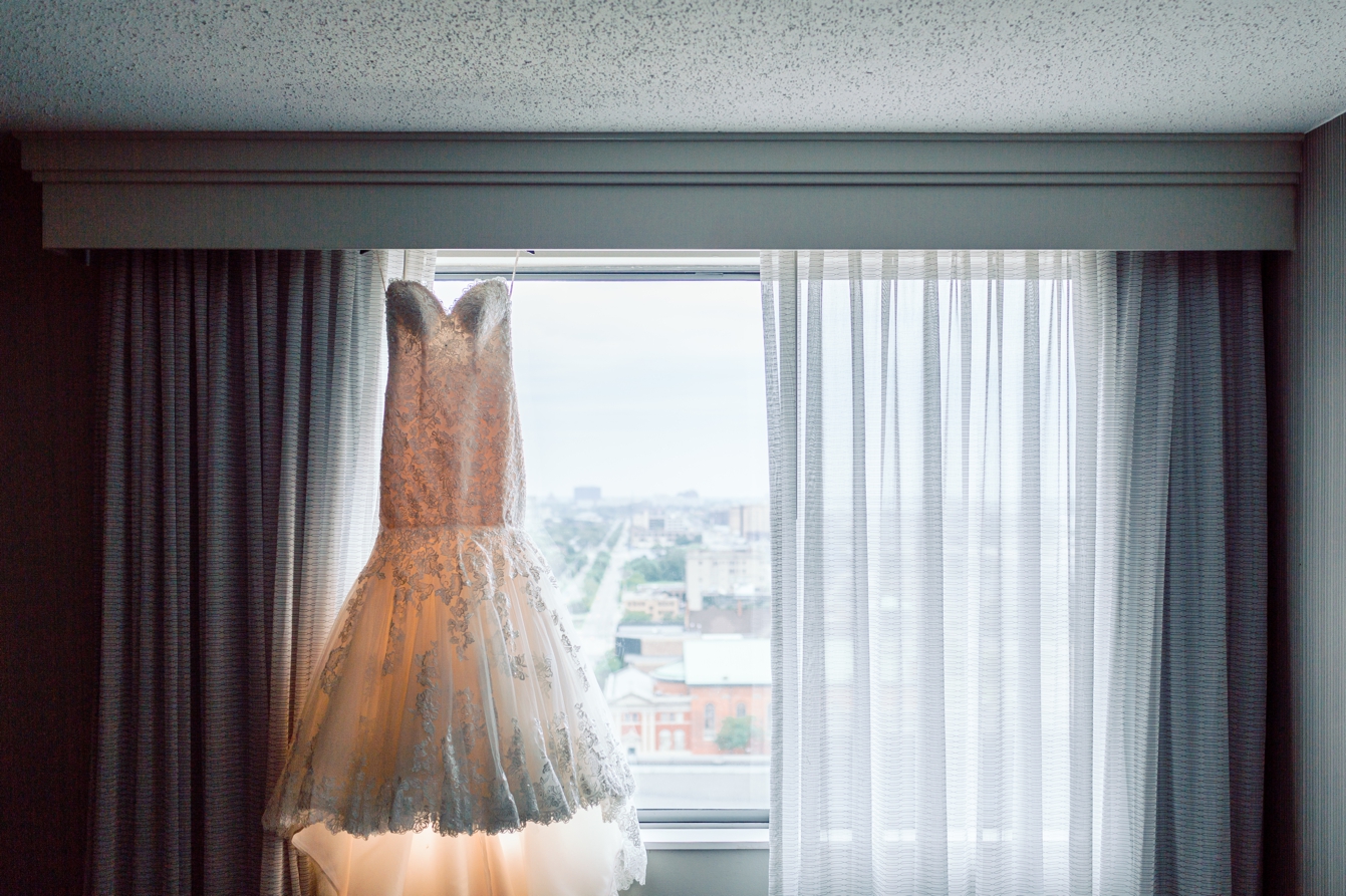 Wedding Dress hanging in the hotel window at Detroit Mariott