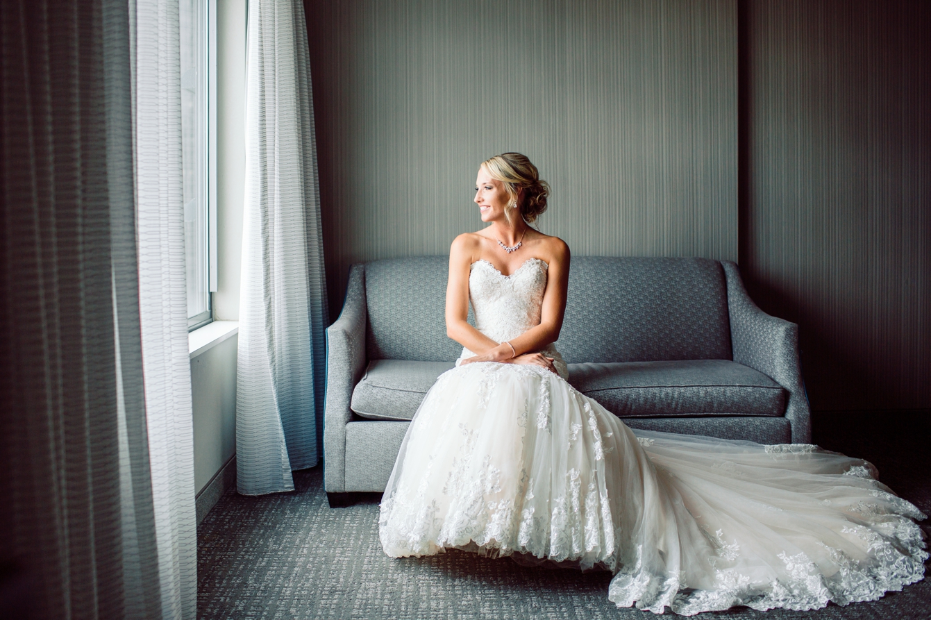 Bride sitting on couch for a portrait in Detroit Michigan