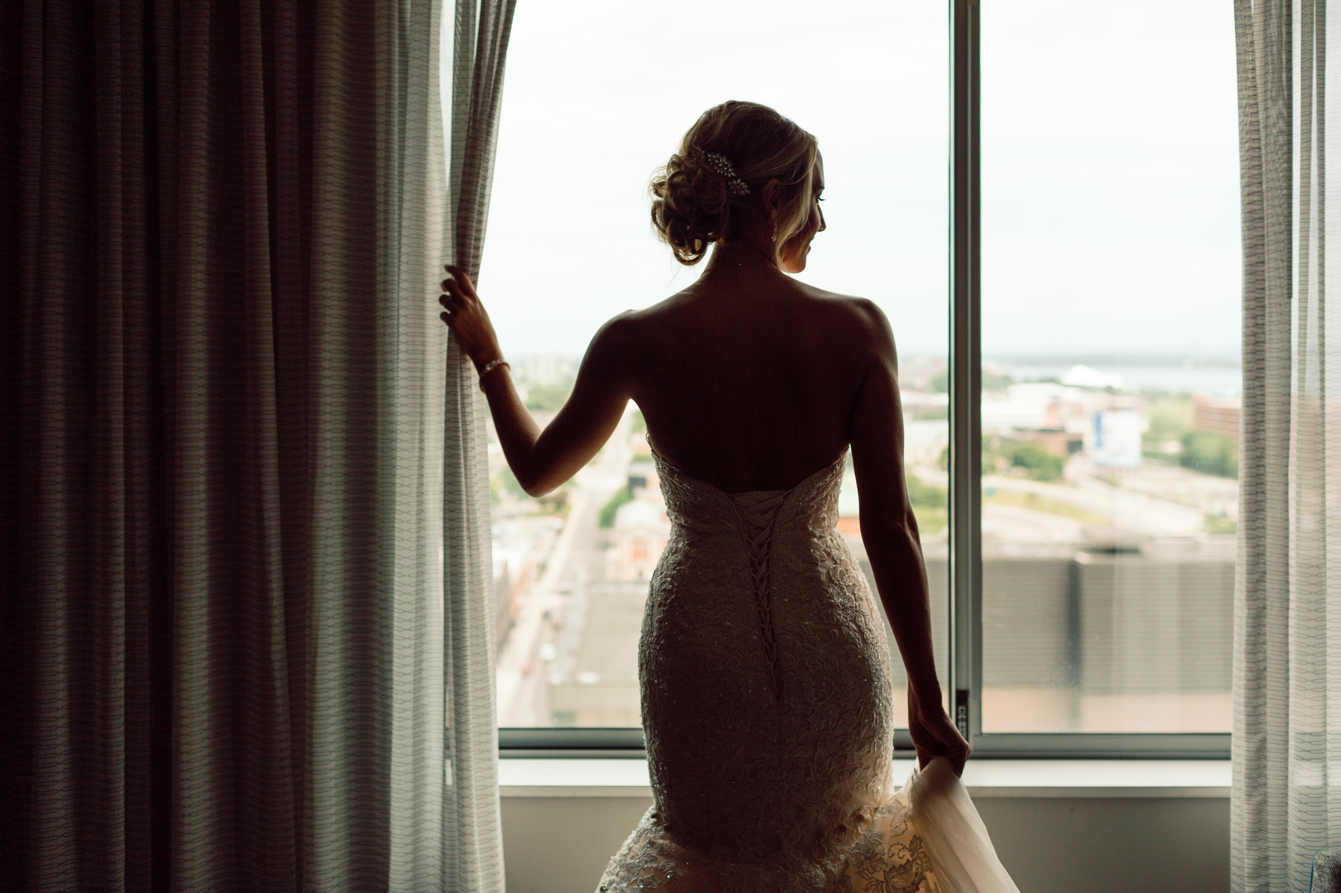 Bride looking out the window at the Detroit Marriott