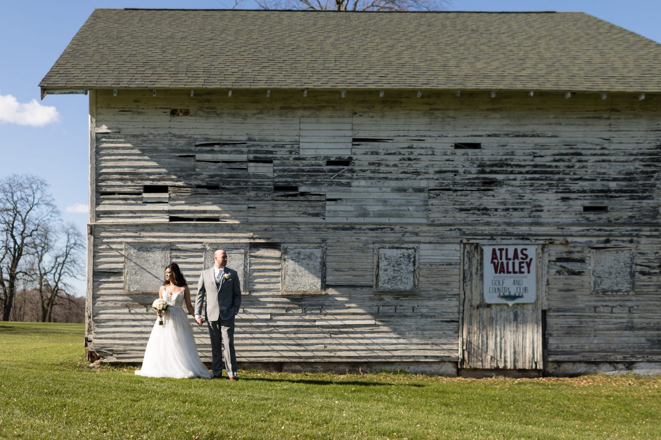 Bride and groom in front of the barn at the Atlas Valley Country Club in Grand Blanc, Michigan