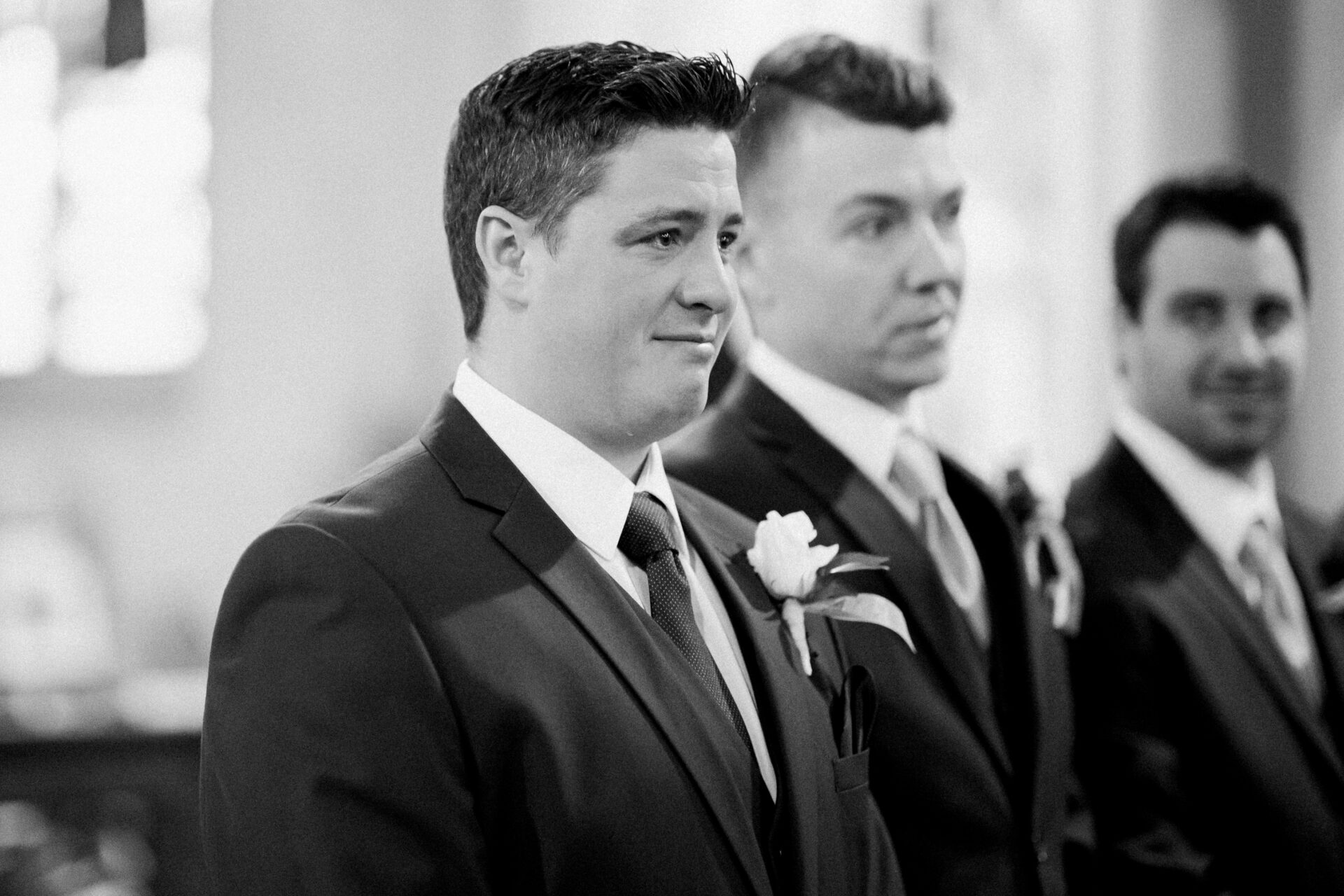 Groom with tears in his eyes at his wedding at Ste. Anne de Detroit by Michele Maloney Photography