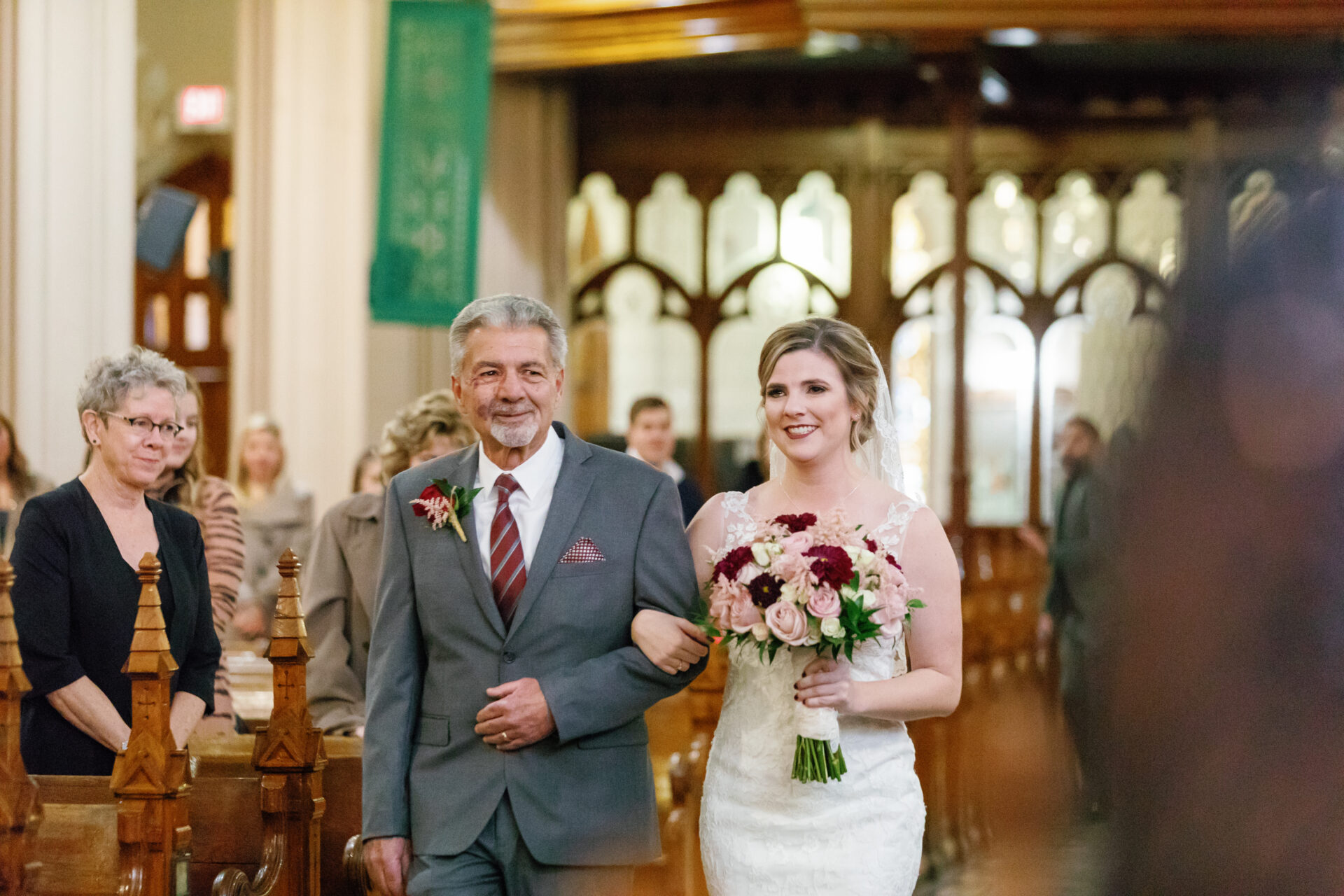 Bride and father walking down the aisle at a fall wedding Ste. Anne de Detroit by Michele Maloney Photography