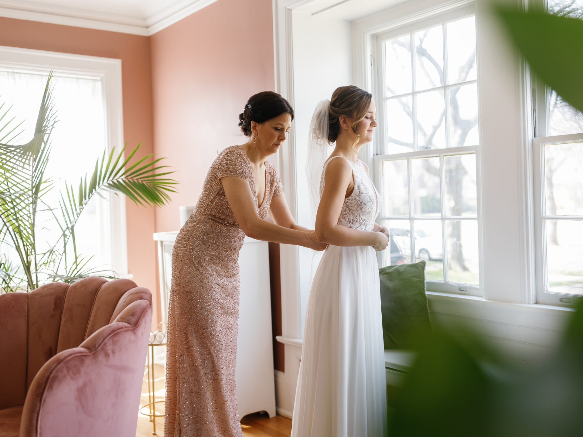 bride getting dressed in the boston edison district before her intimate wedding at the Eastern Market in Detroit by Michele Maloney Photography