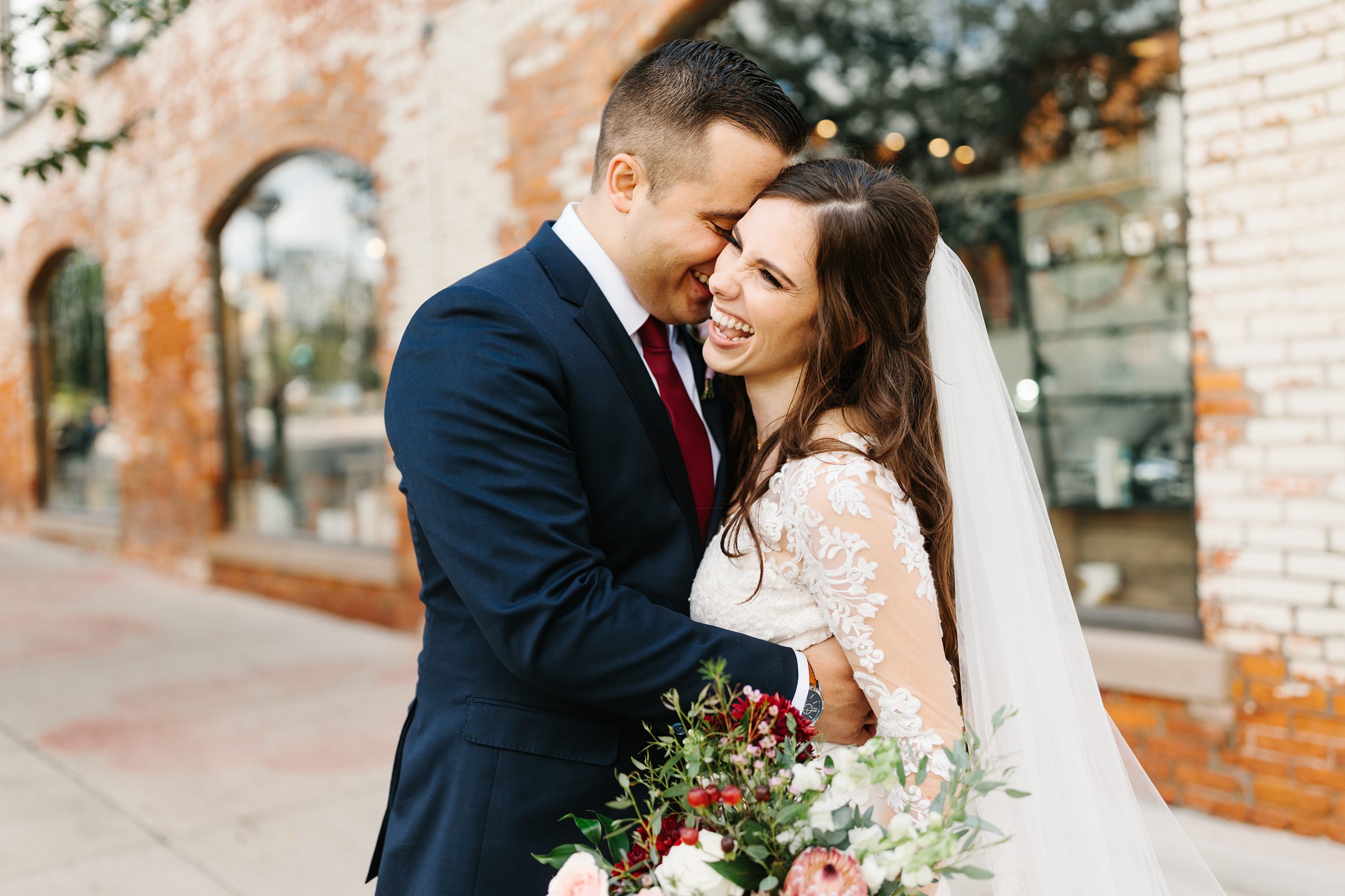 Bride and groom snuggle close and smile for their Ann Arbor intimate wedding by Detroit Wedding Photographer Michele Maloney