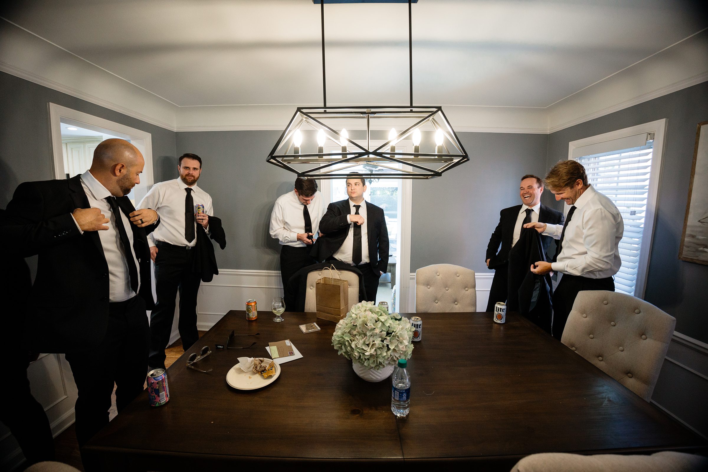 Groomsmen get ready at a house by Detroit Wedding Photographer Michele Maloney