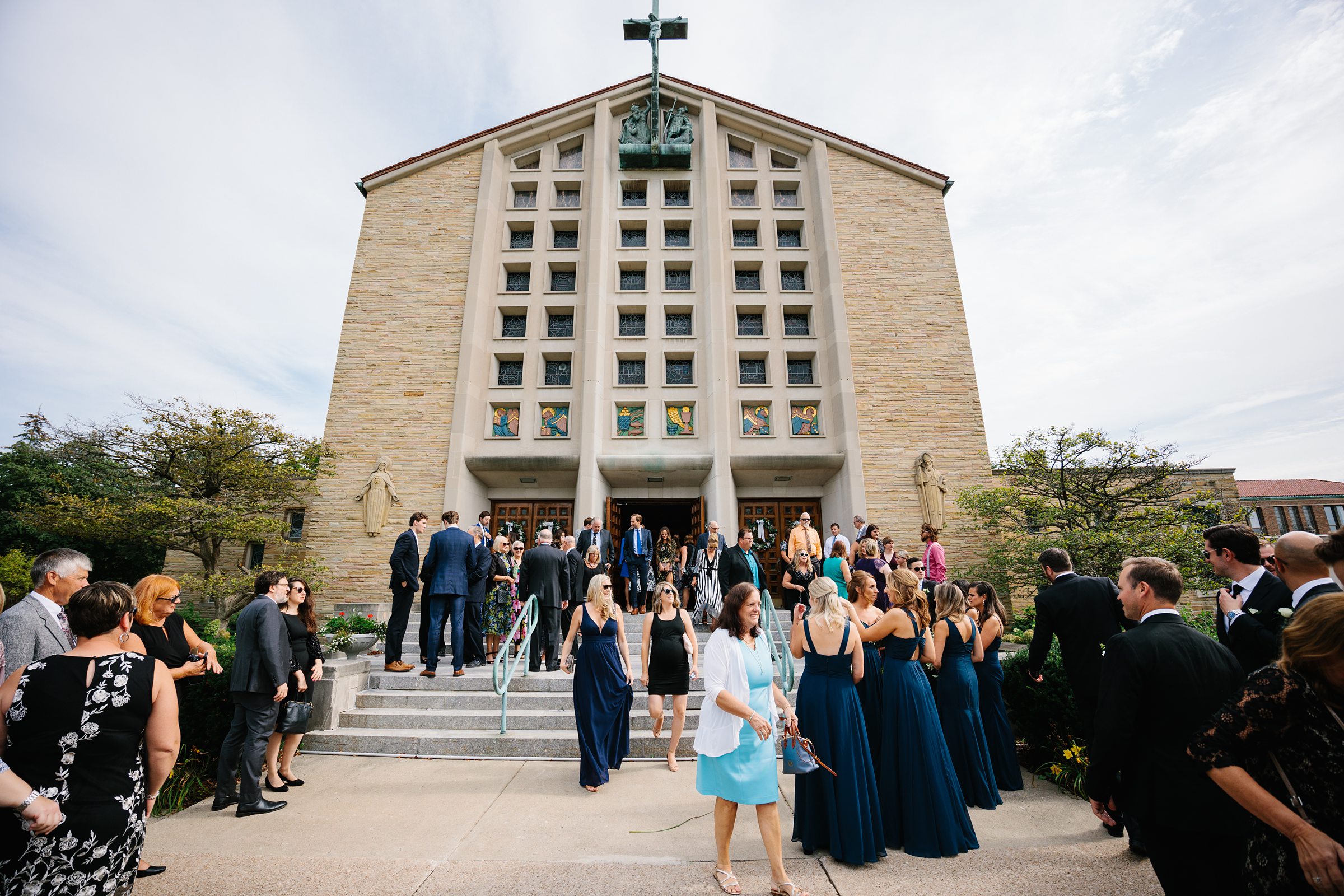 Shot of the wedding guests outside the church by Detroit Wedding Photographer Michele Maloney