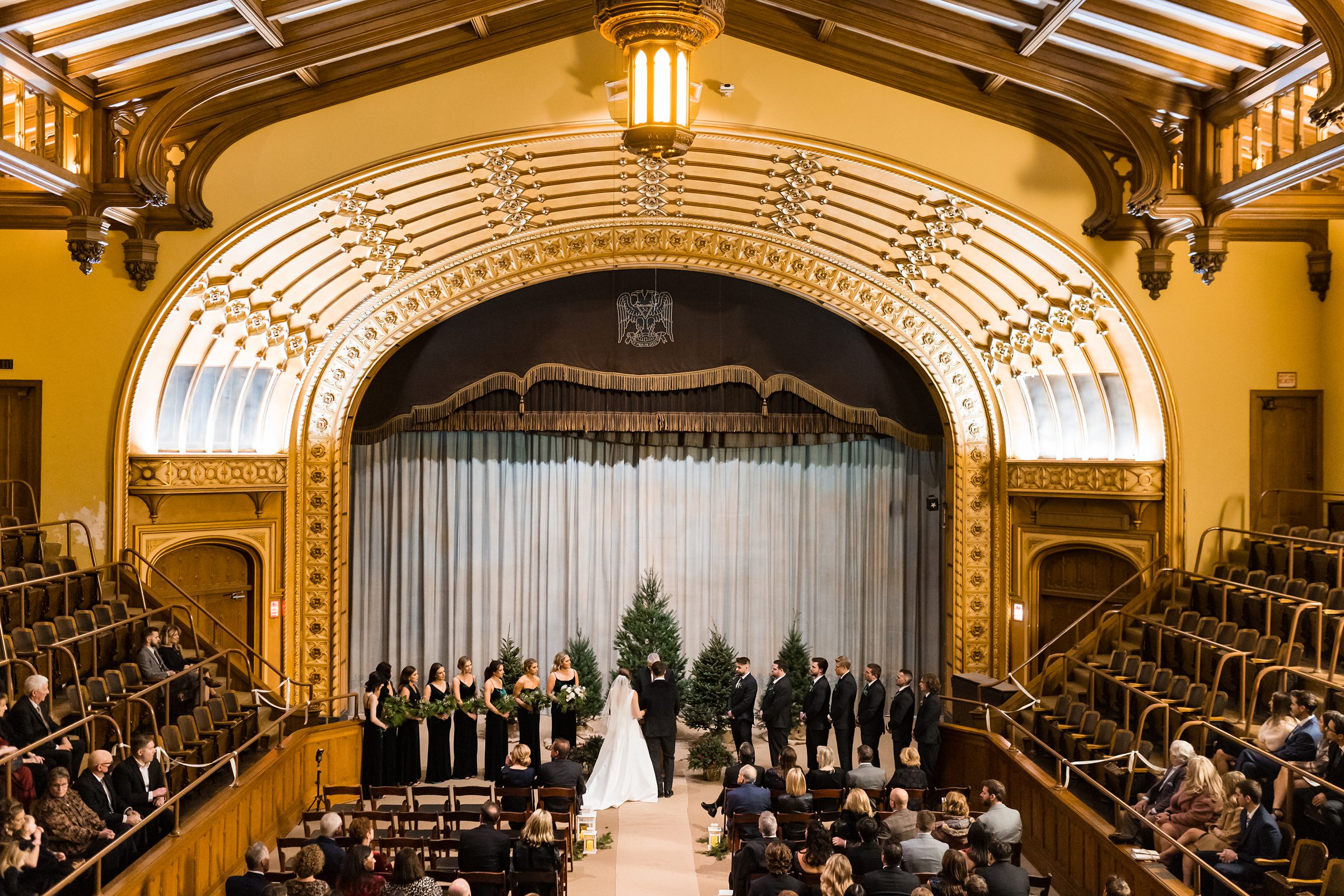 Faraway shot of the ceremony with guests and bridal party in view by Detroit Wedding Photographer Michele Maloney