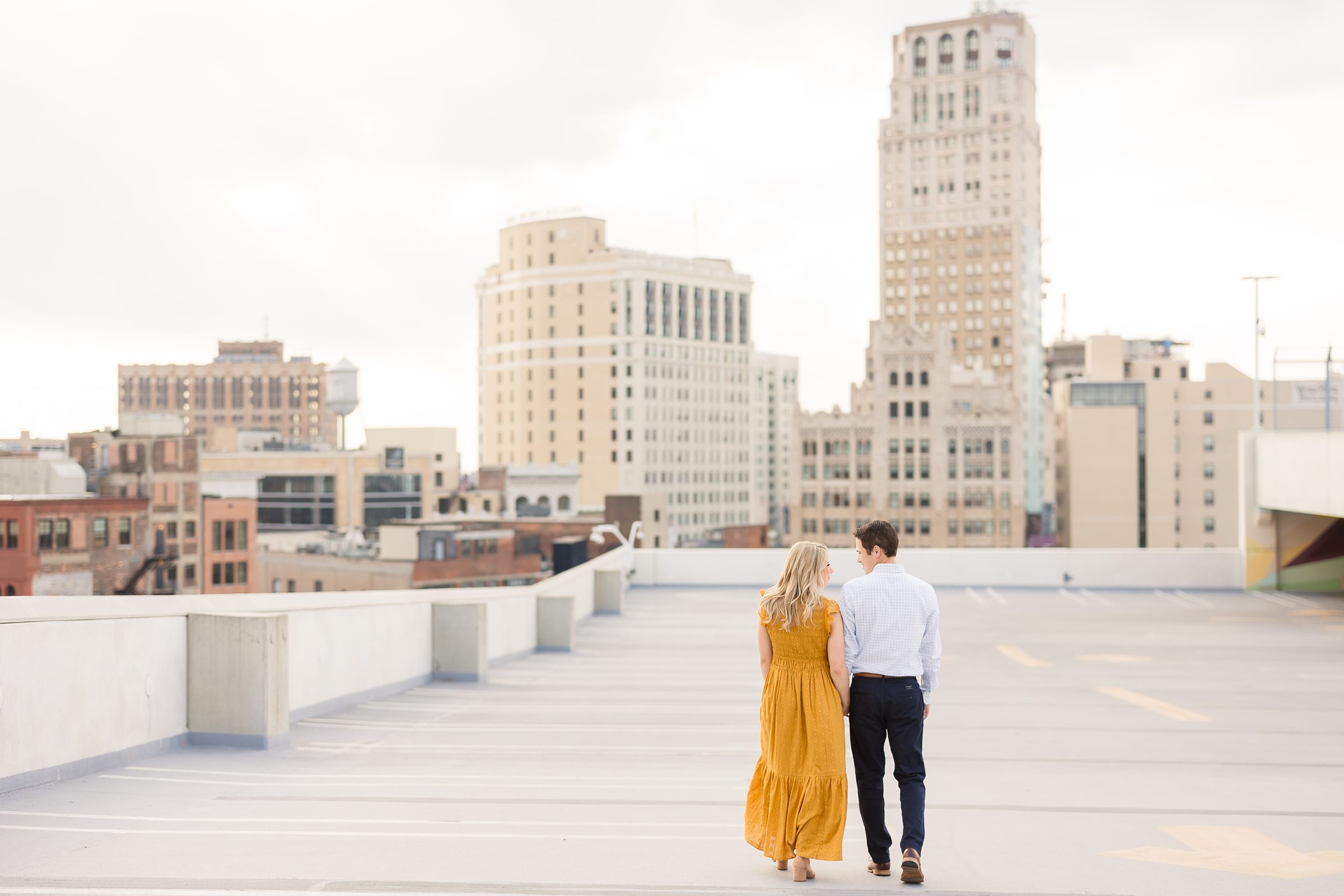 Couple walking on the rooftop of the Z deck parking garage in Detroit Michigan 