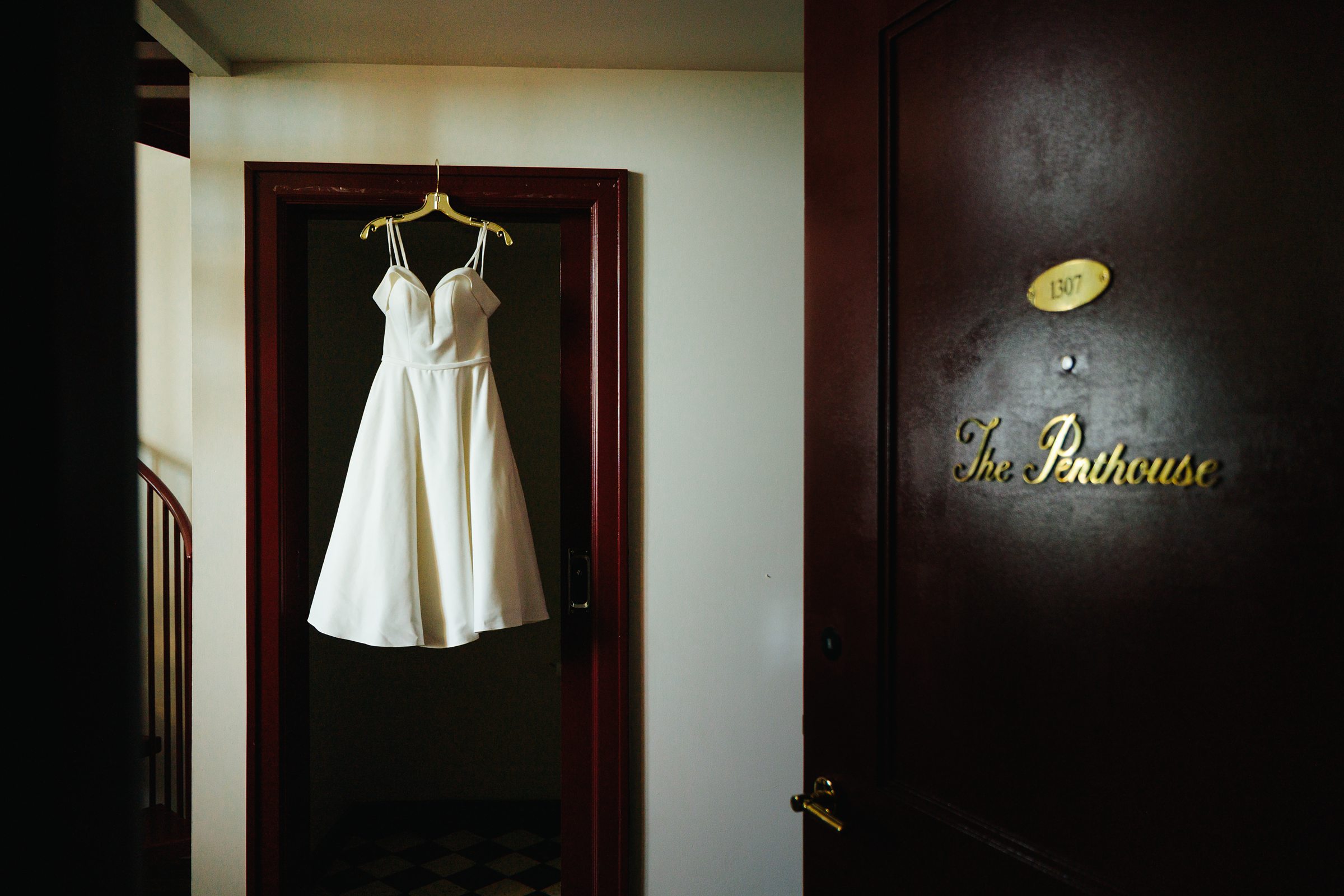 Wedding Dress hanging in the Penthouse Suite at the Siren Hotel by Detroit Wedding Photographer Michele Maloney