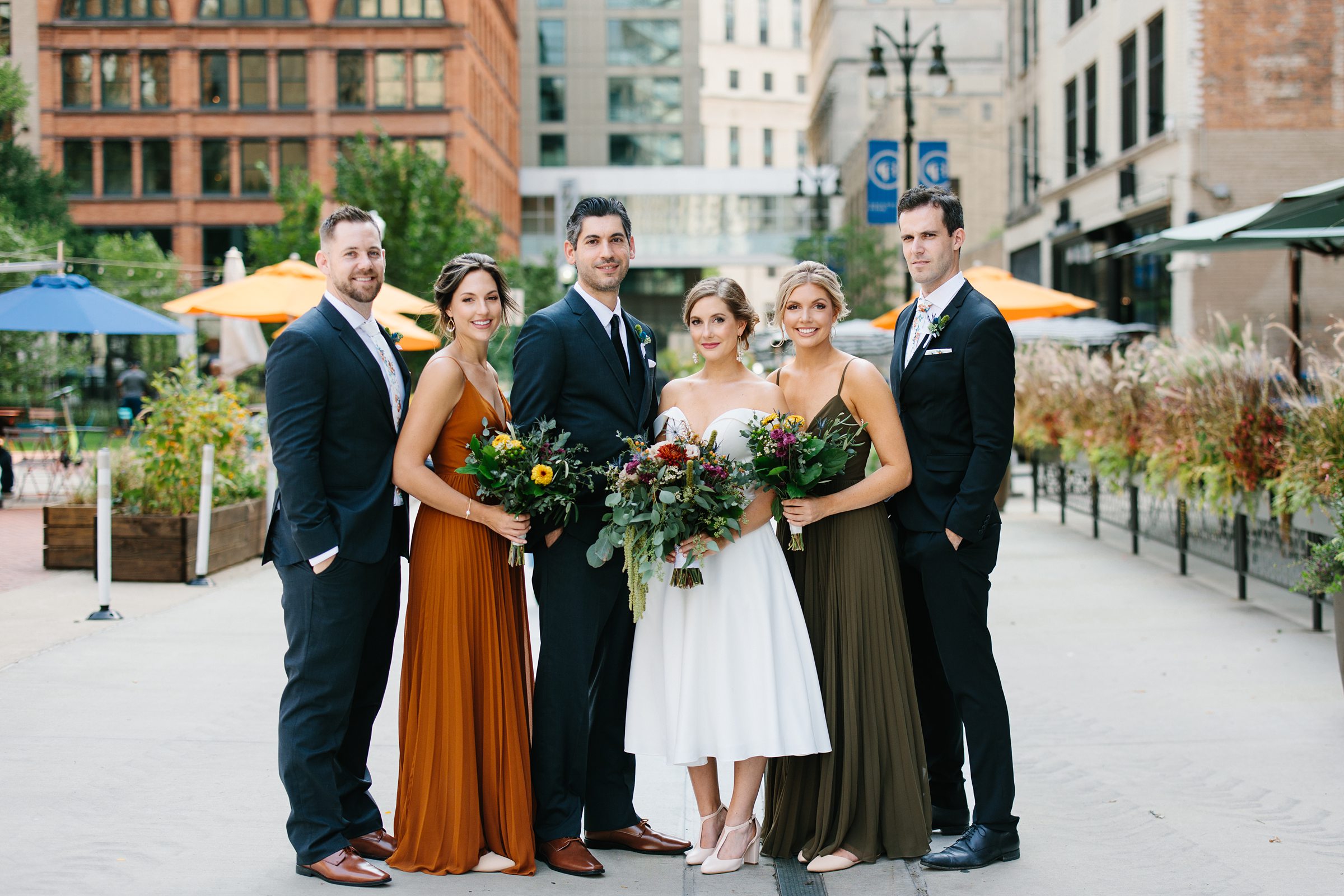 Bridal party poses for formal portraits in downtown Detroit by Detroit Wedding Photographer Michele Maloney
