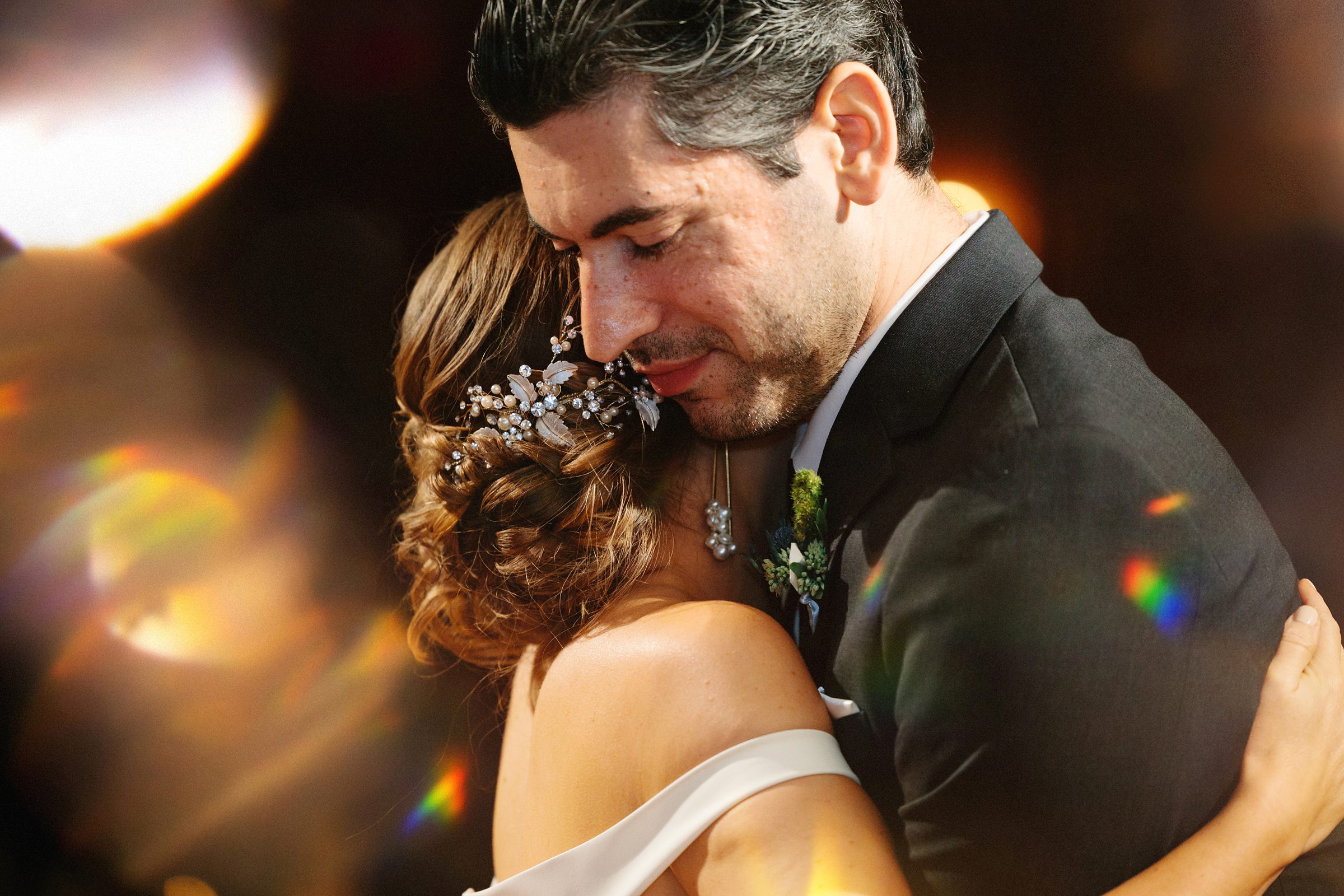 Closeup shot of the bride and groom dancing cheek to cheek by Detroit Wedding Photographer Michele Maloney