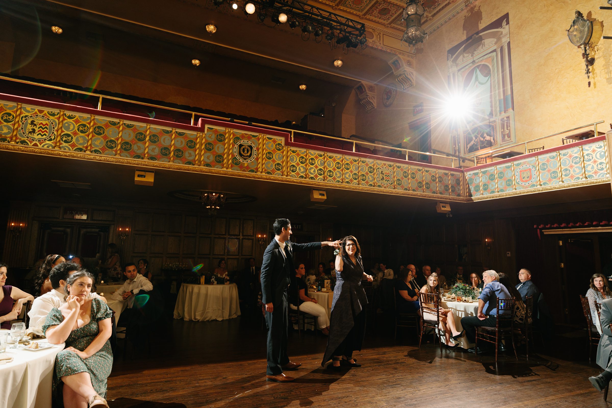 Mother and son dance takes place on the dance floor at the Gem Theater by Detroit Wedding Photographer Michele Maloney