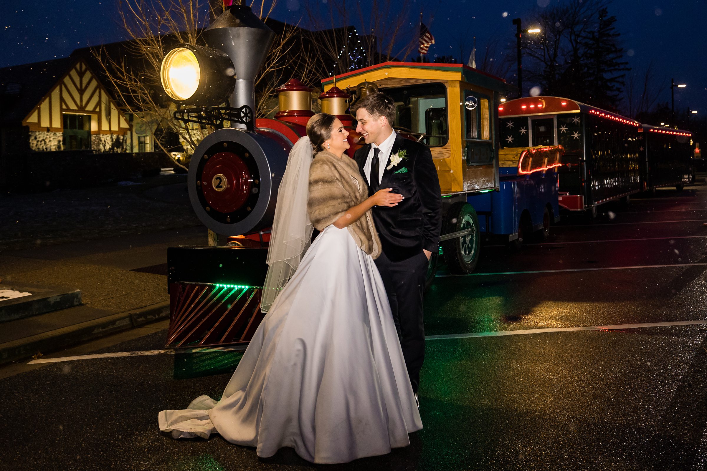 Bride and groom grin at each other with whimsical train behind them by Detroit Wedding Photographer Michele Maloney 
