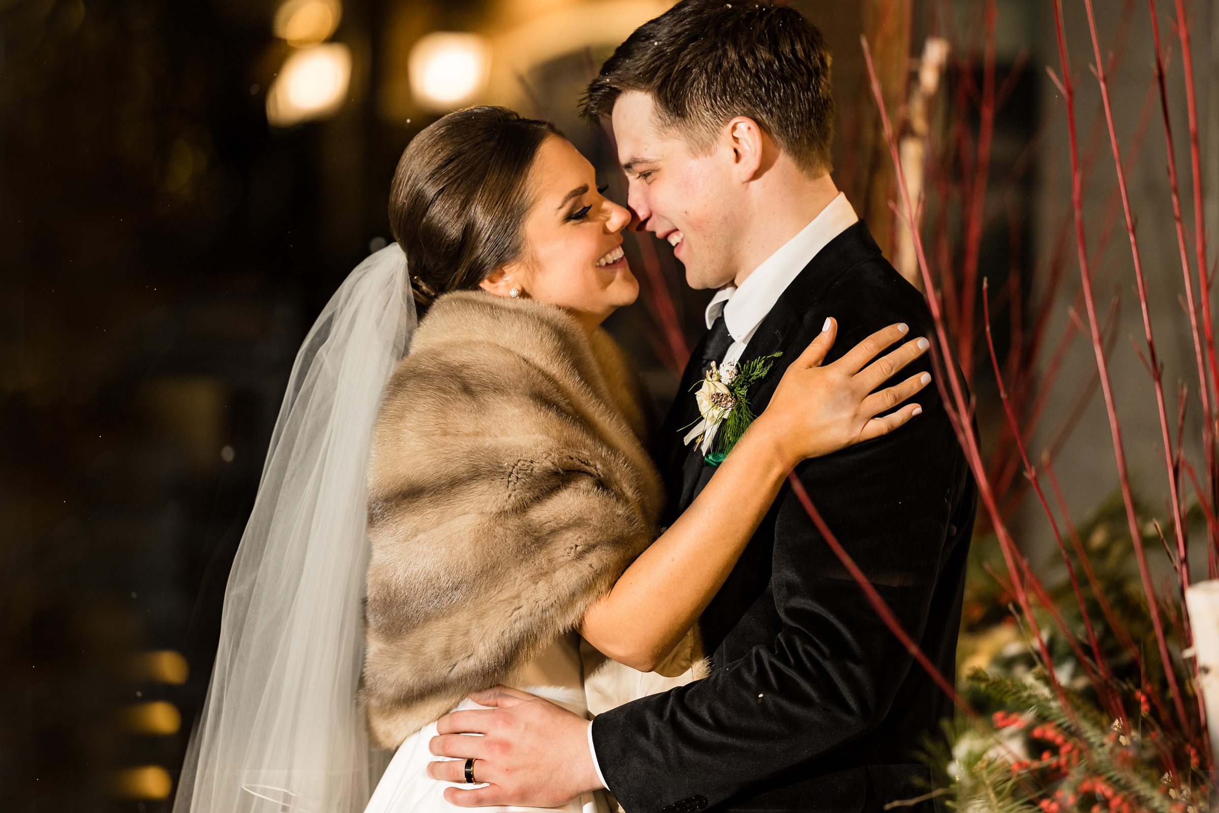Bride and groom give eskimo kisses outside in the winter air by Detroit Wedding Photographer Michele Maloney