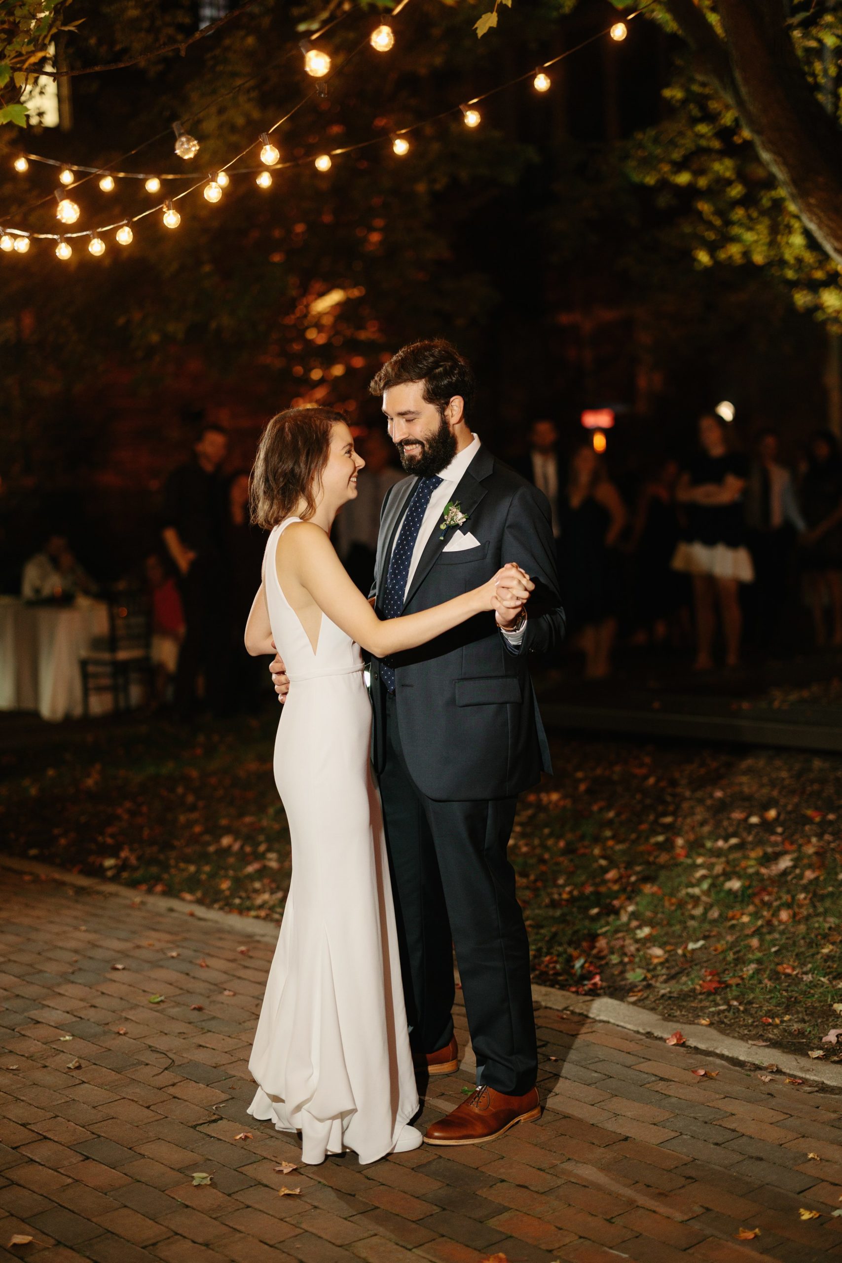 Bride and groom smile as they slow dance outside at The Inn at the Michigan League Wedding reception by Detroit Wedding Photographer Michele Maloney