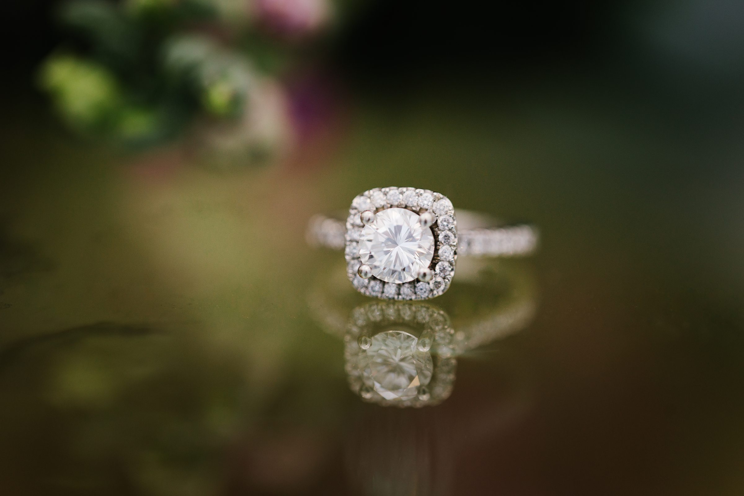Close up of bride's ring on reflective table by Detroit Wedding Photographer Michele Maloney