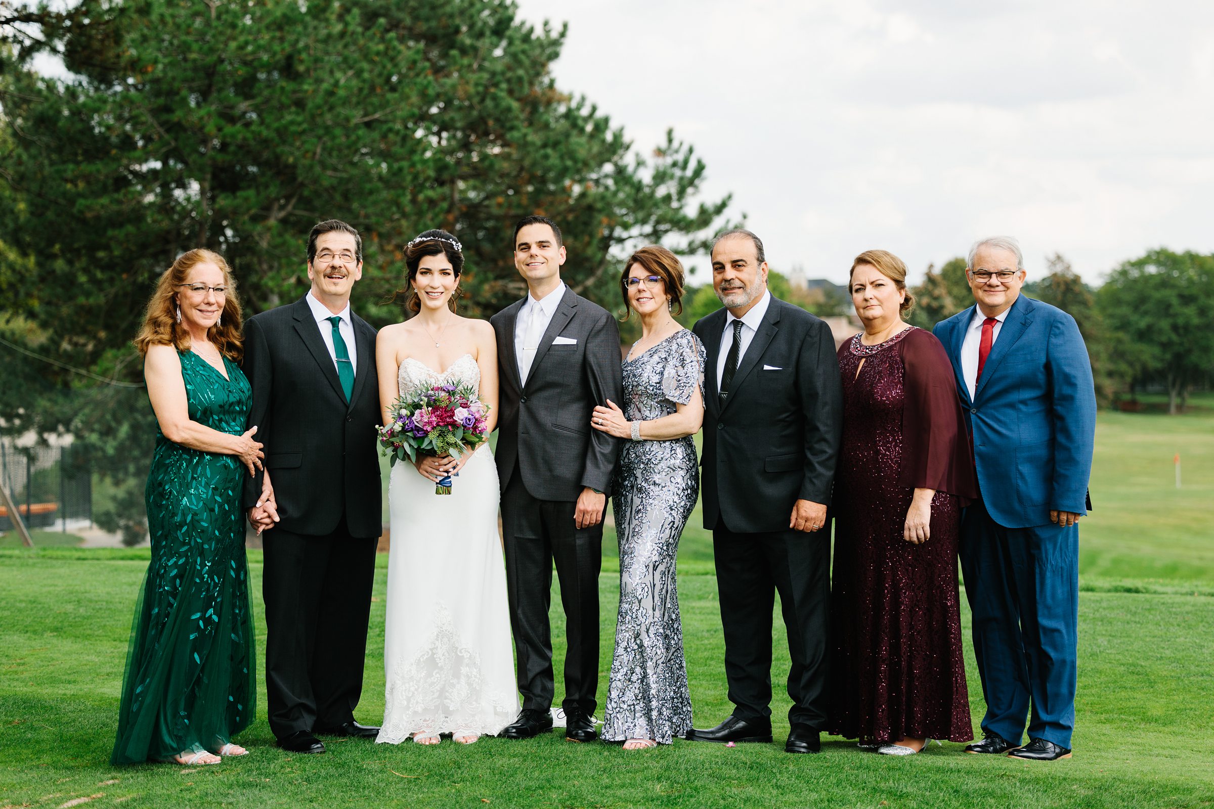 Bride and groom take portraits with family by Detroit Wedding Photographer Michele Maloney