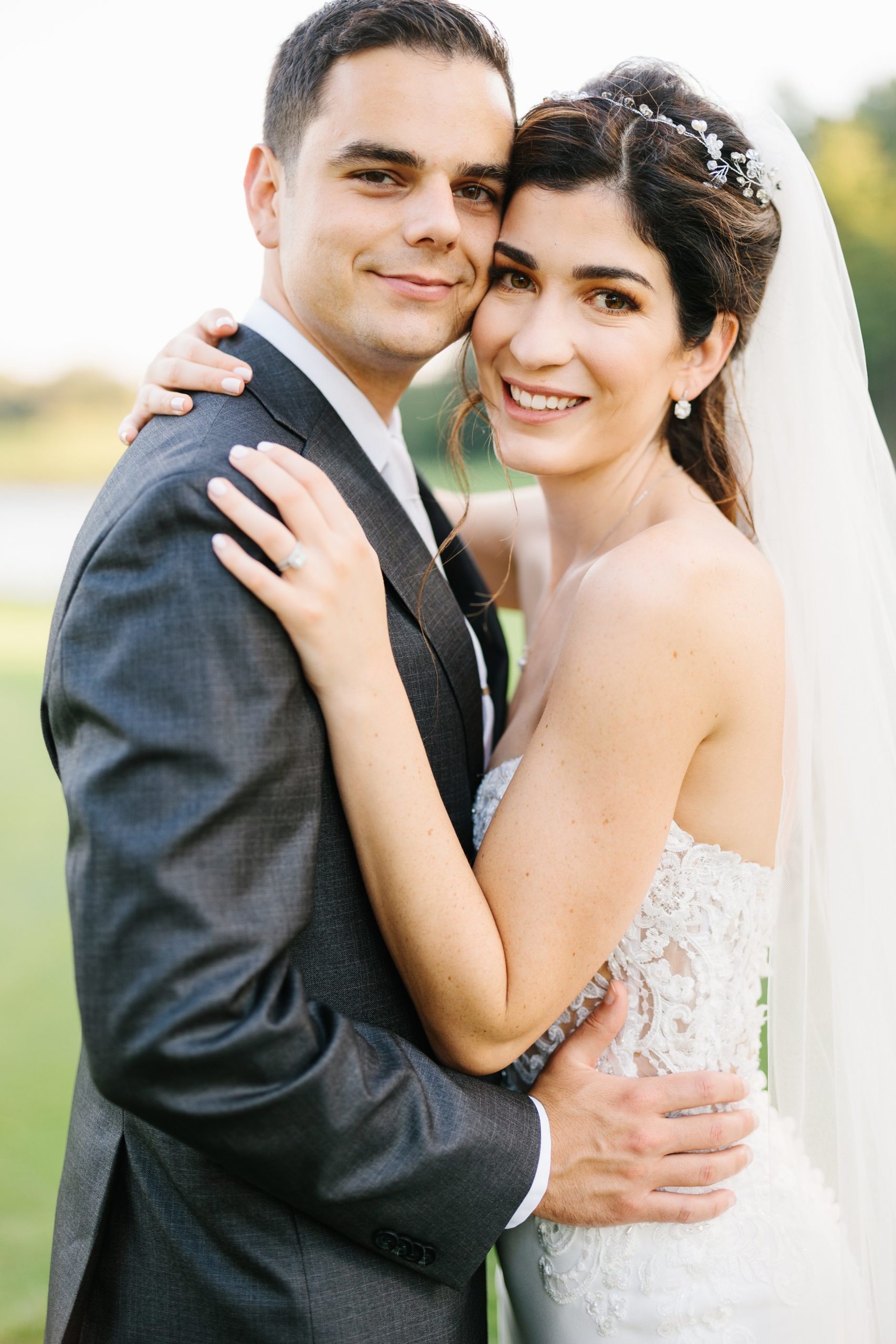 Bride and groom take close up portrait, smiling for camera by Detroit Wedding Photographer Michele Maloney