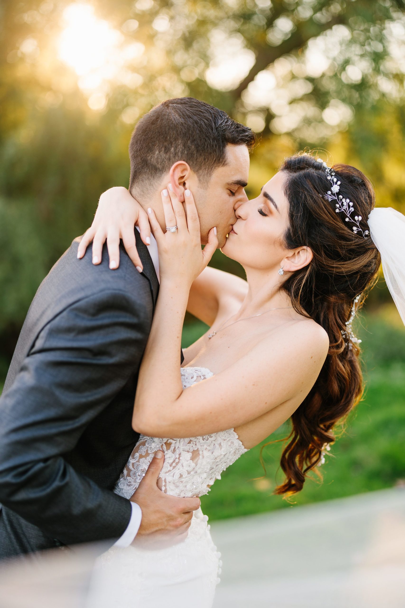Bride and groom kiss and lean back by Detroit Wedding Photographer Michele Maloney