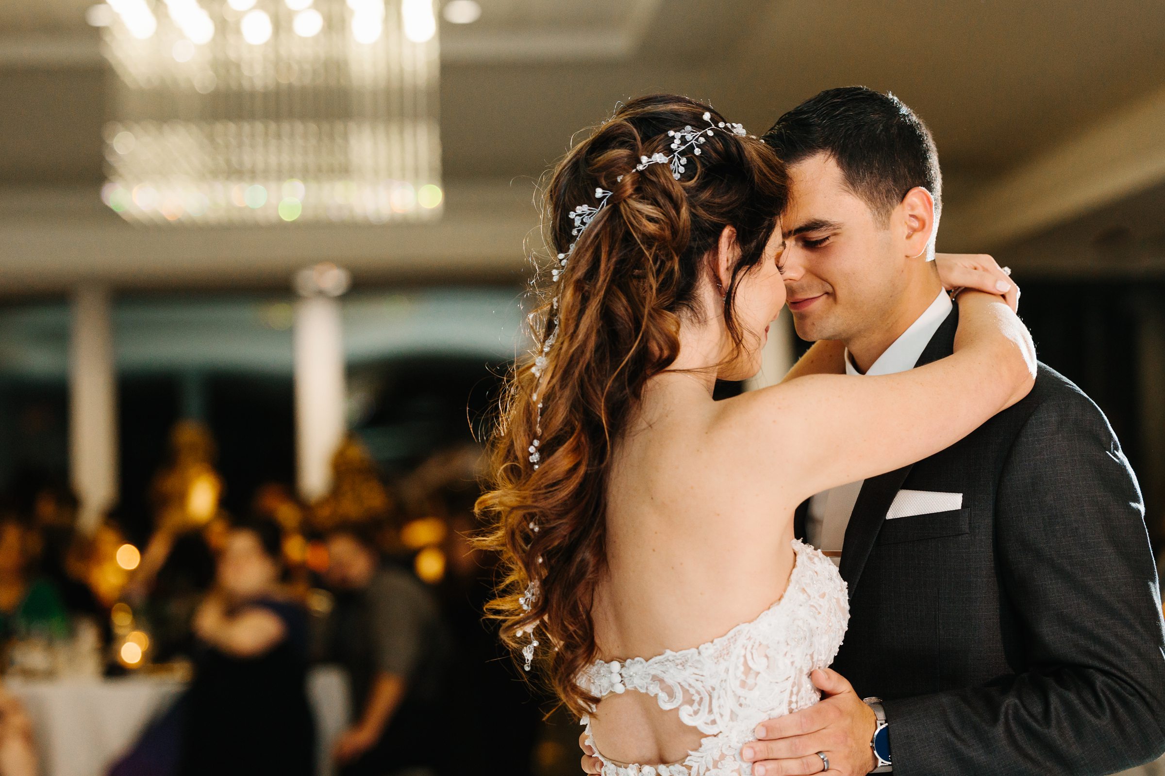 Bride and groom cozy up close during their first dance by Detroit Wedding Photographer Michele Maloney