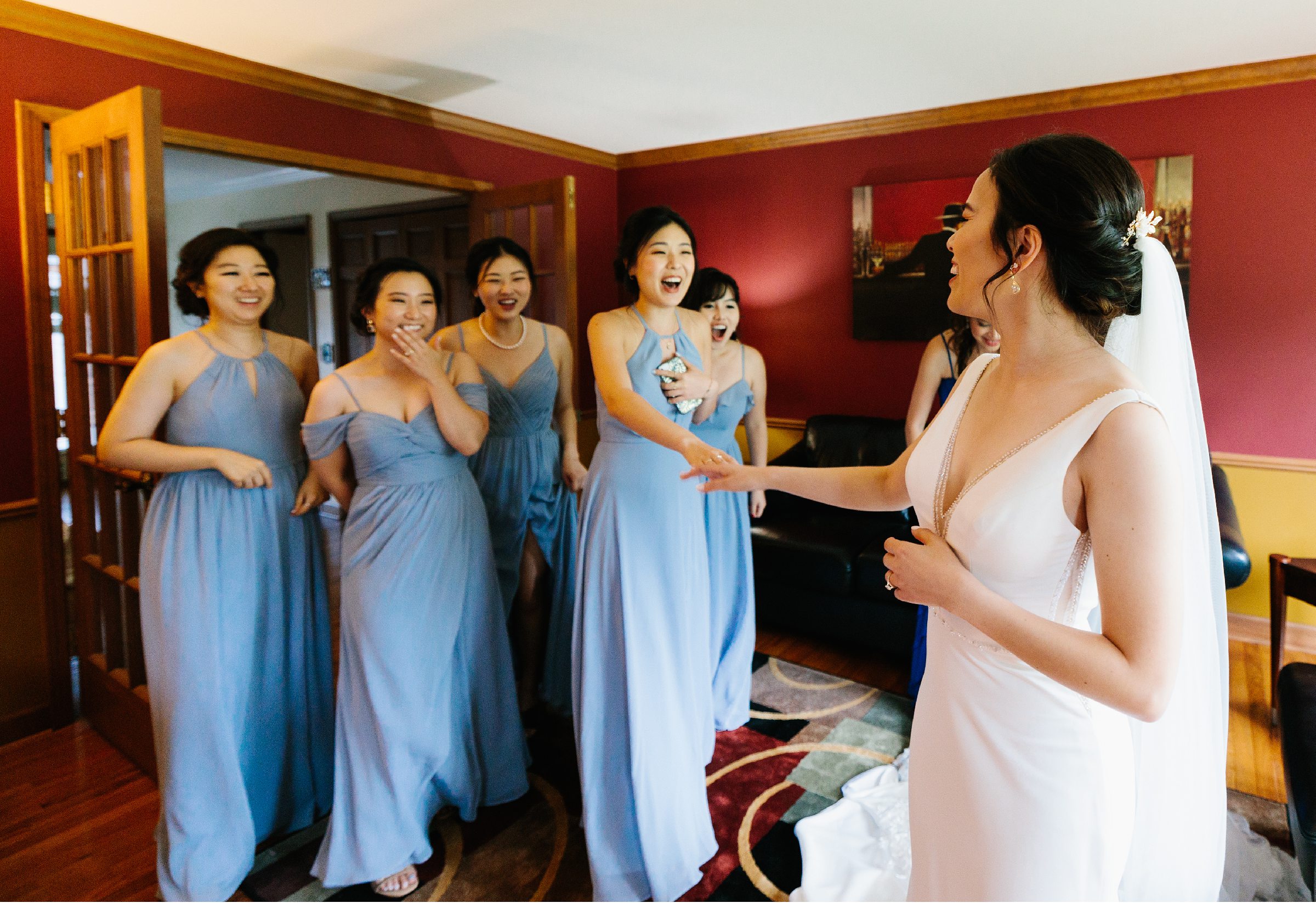 First look with bridesmaids in bride's wedding dress by Detroit Wedding Photographer Michele Maloney