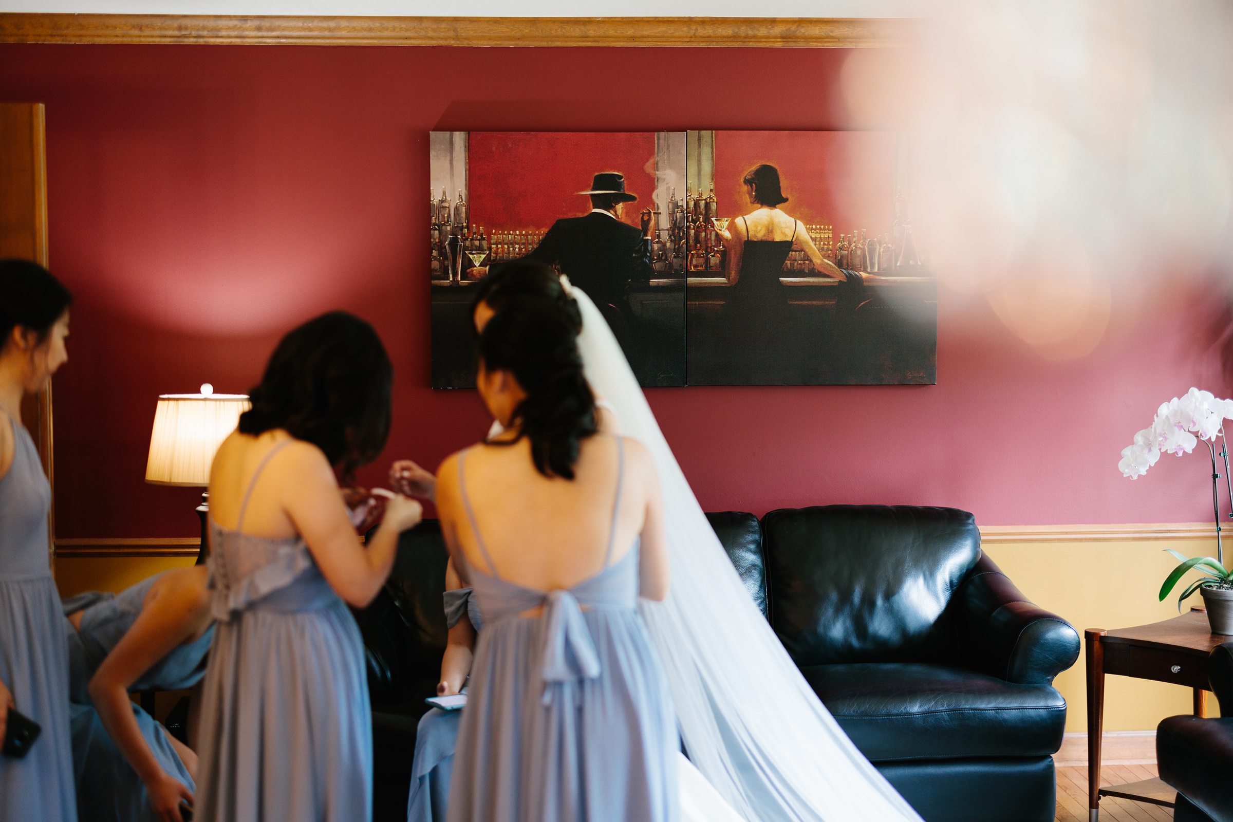 Bridesmaids help the bride make final adjustments before the first look by Detroit Wedding Photographer Michele Maloney