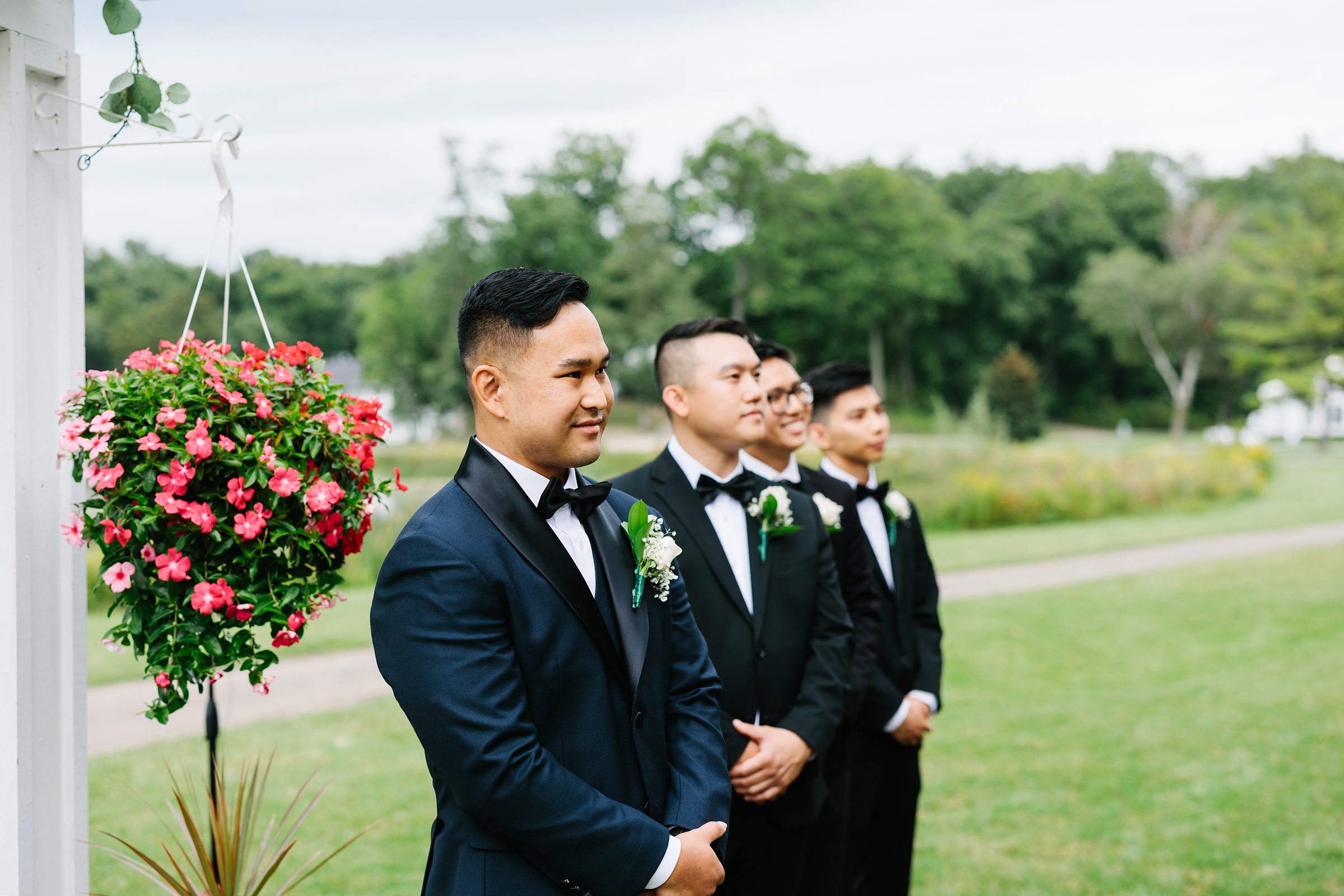 Groom and groomsmen watch as bride walks down the aisle for the Waldenwoods Summer wedding by Detroit Wedding Photographer Michele Maloney