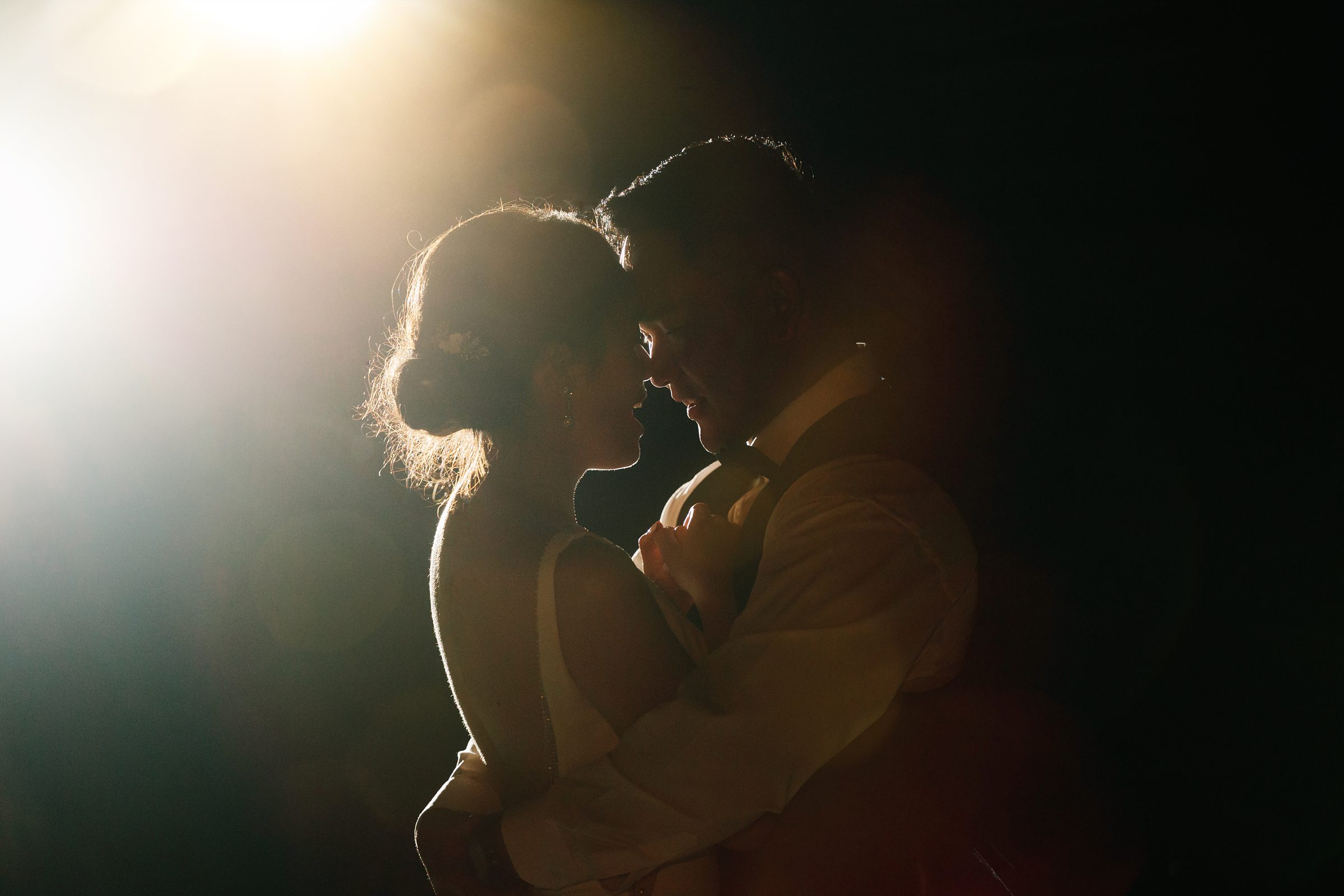 Evening shot of the bride and groom cozying up close by Detroit Wedding Photographer Michele Maloney