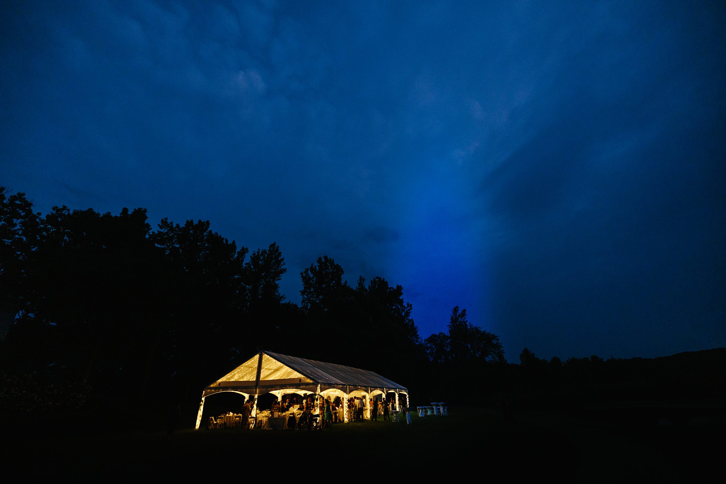 Faraway evening shot of the Waldenwoods Summer Wedding reception by Detroit Wedding Photographer Michele Maloney