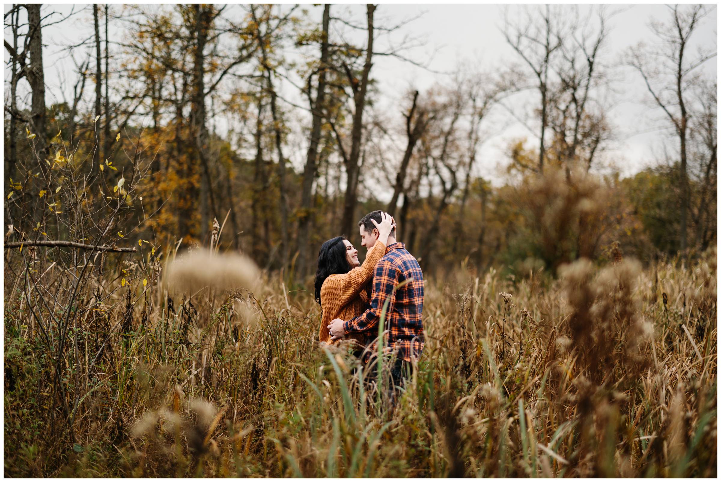 Faraway shot of engaged couple embracing at Kensington Metropark by Detroit Wedding Photographer Michele Maloney
