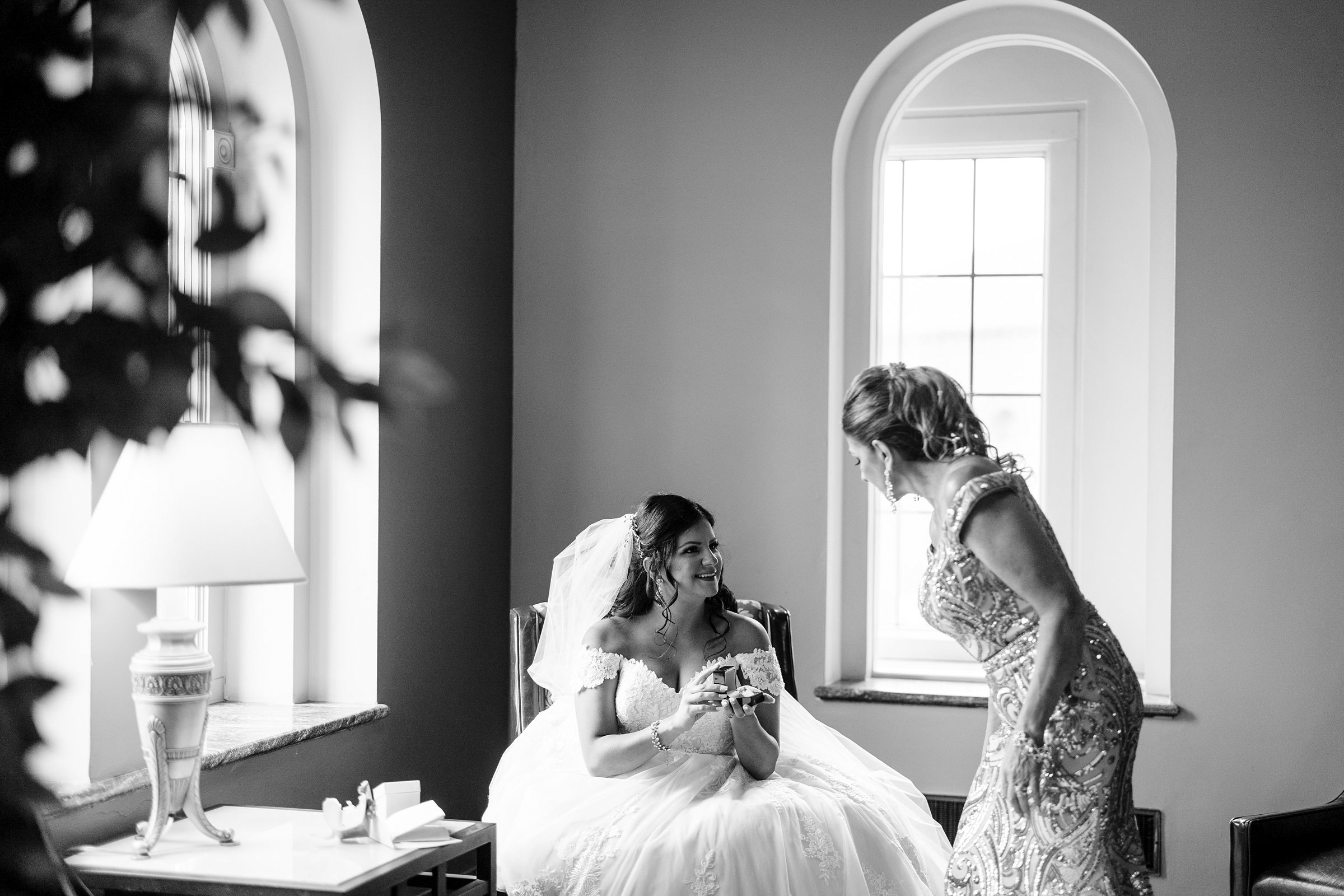 Bride showing mom a gift at the Inn at St Johns by Michele Maloney Photography