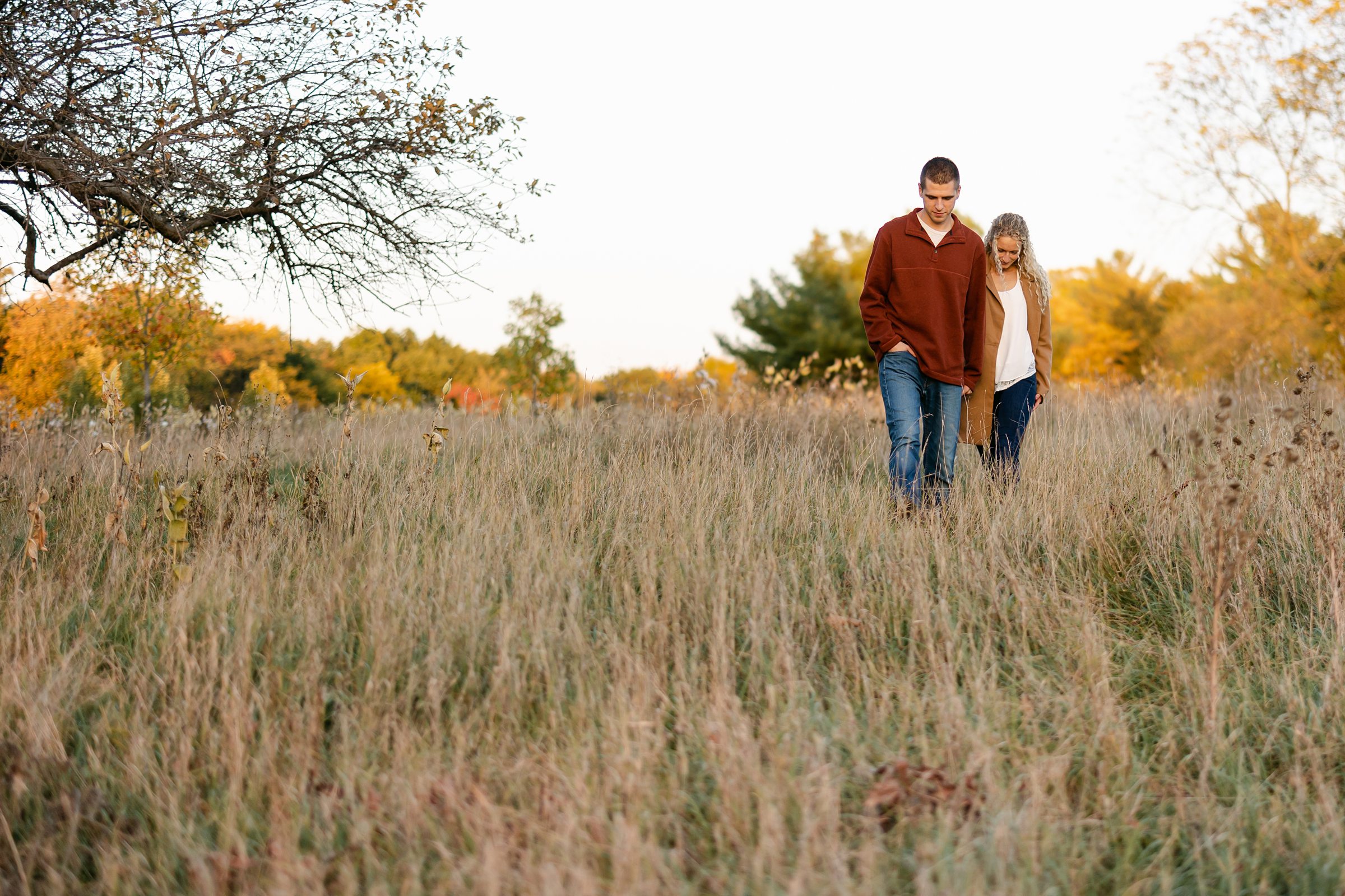Couple walking through the field at Kensington Metropark in Milford Michigan by Michele Maloney Photography
