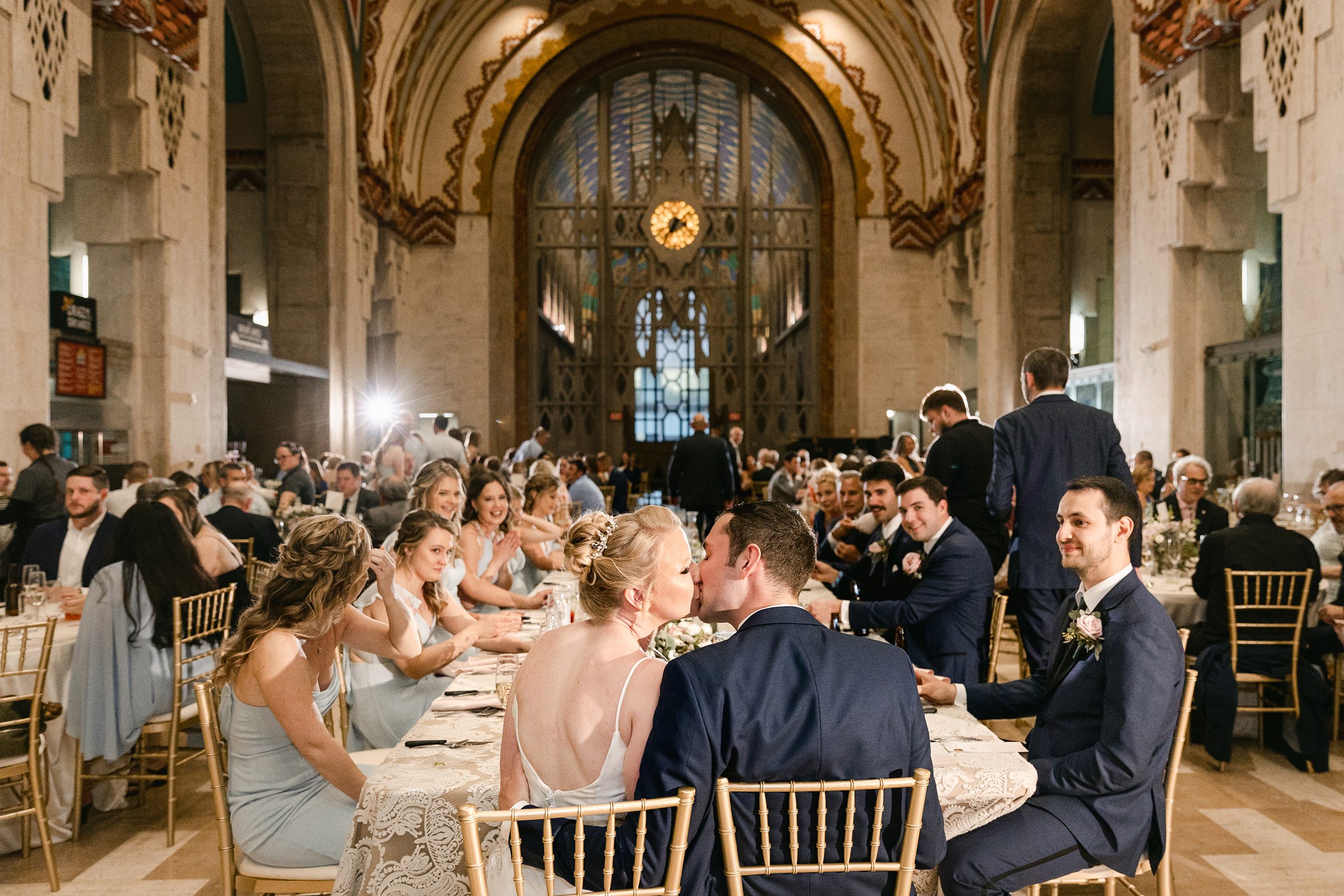 Bride and Groom at their dinner table during toasts at the Guardian Building in Detroit by Michele Maloney Photography