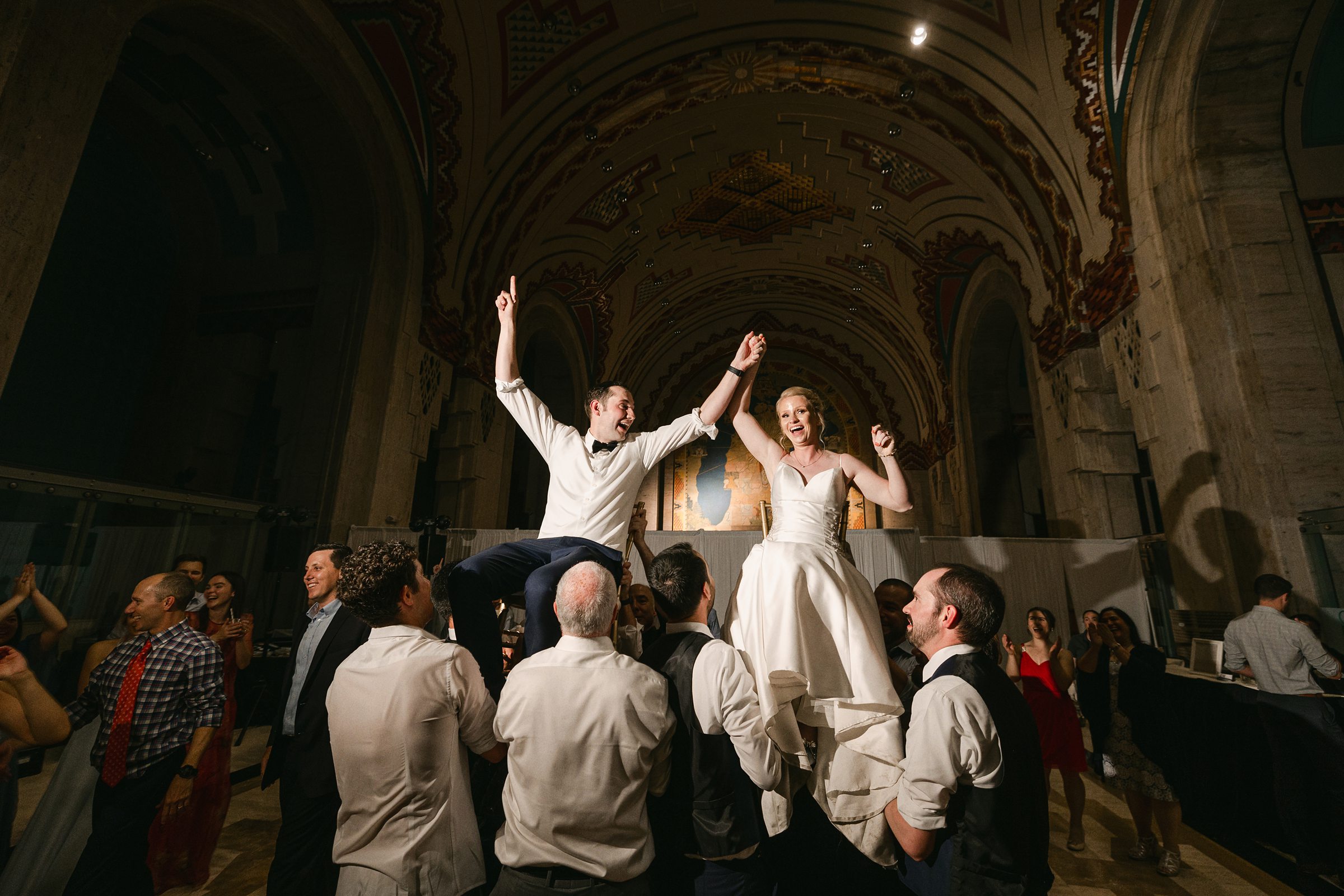 bride and groom on chairs during the reception at the Guardian Building in Detroit by Michele Maloney Photography
