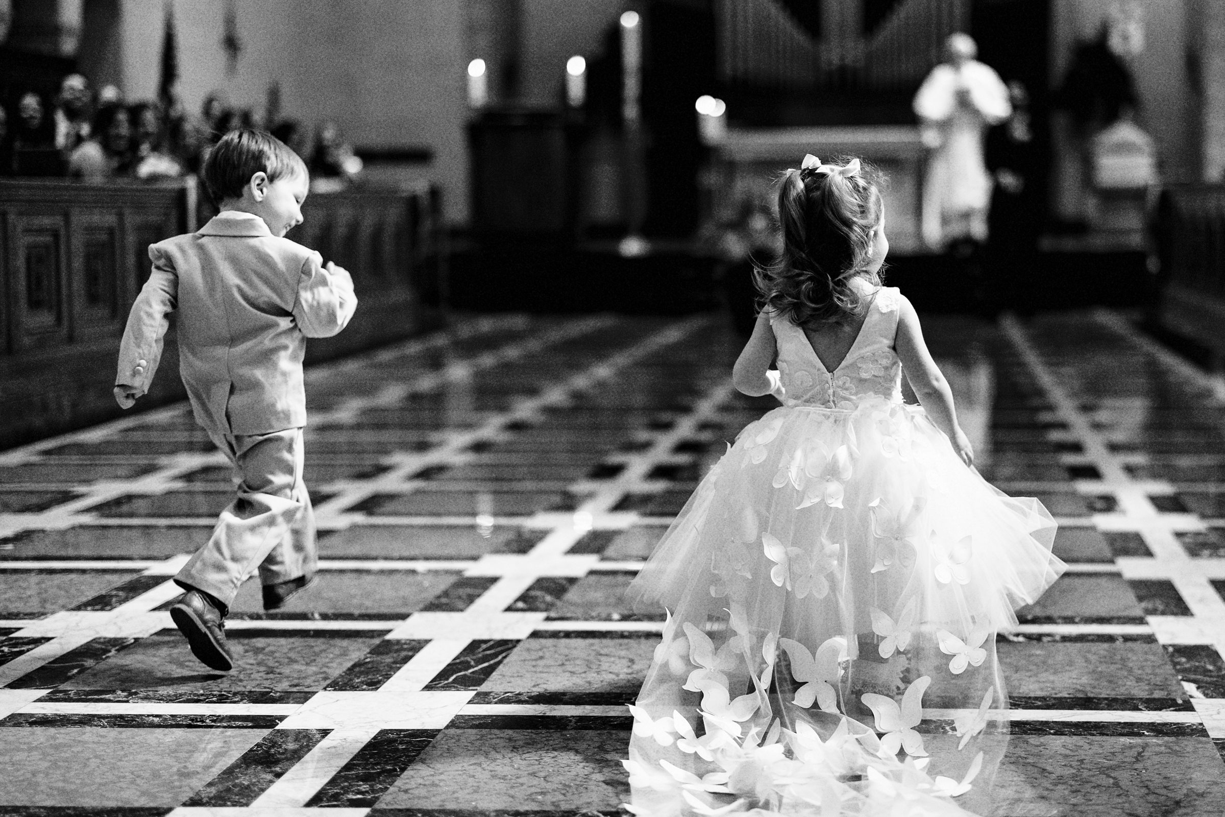ringbearer and flower girl running down the aisle at Saint John's Resort by Michele Maloney Photography