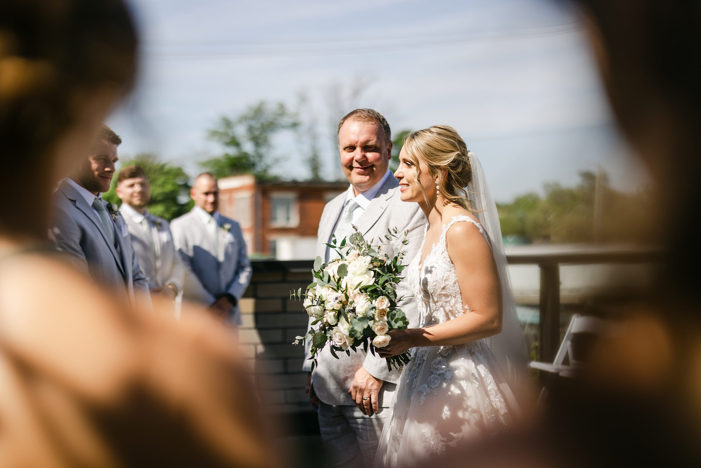dad giving away his bride on the rooftop at Port 393 in Holland Michigan by Michele Maloney Photography