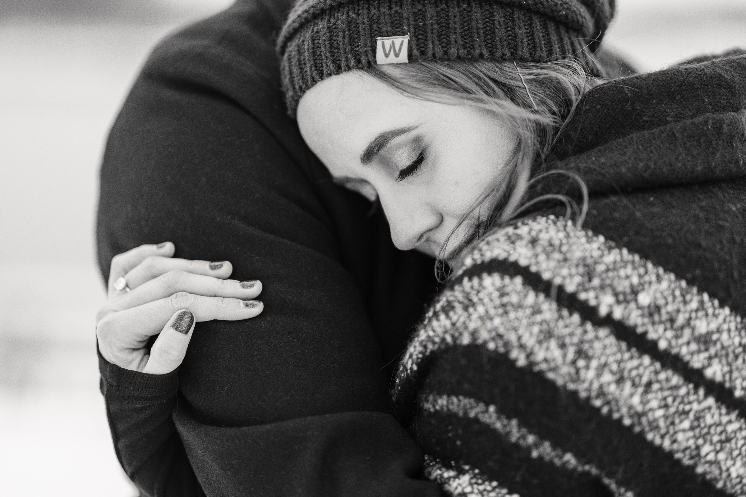 woman putting her head on her fiance during their kensington winter engagement session by Michele Maloney Photography