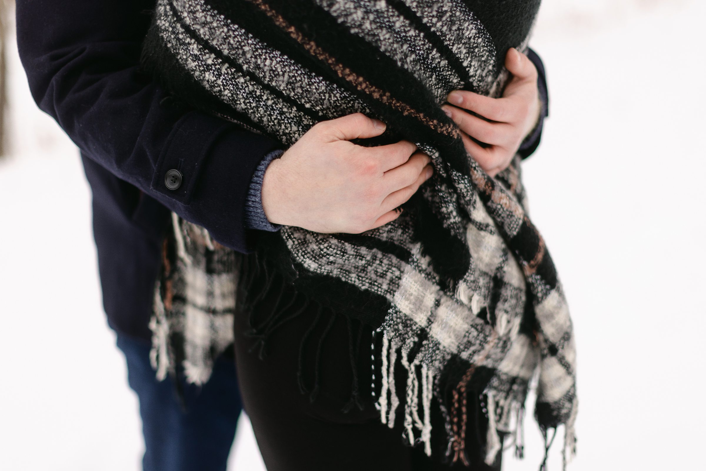 snuggling couple during their kensington winter engagement session by Michele Maloney Photography