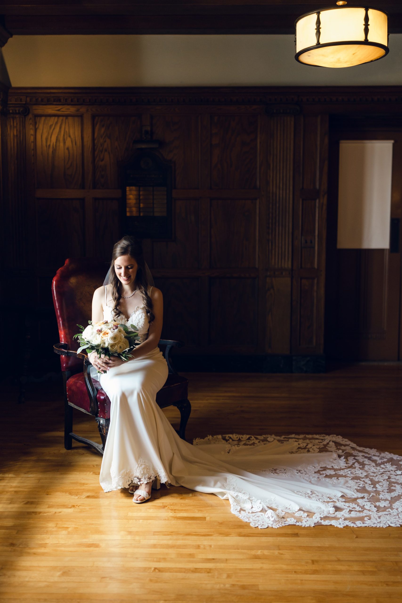 bride smiling with her flowers at the Masonic Temple in Detroit by Michele Maloney Photography