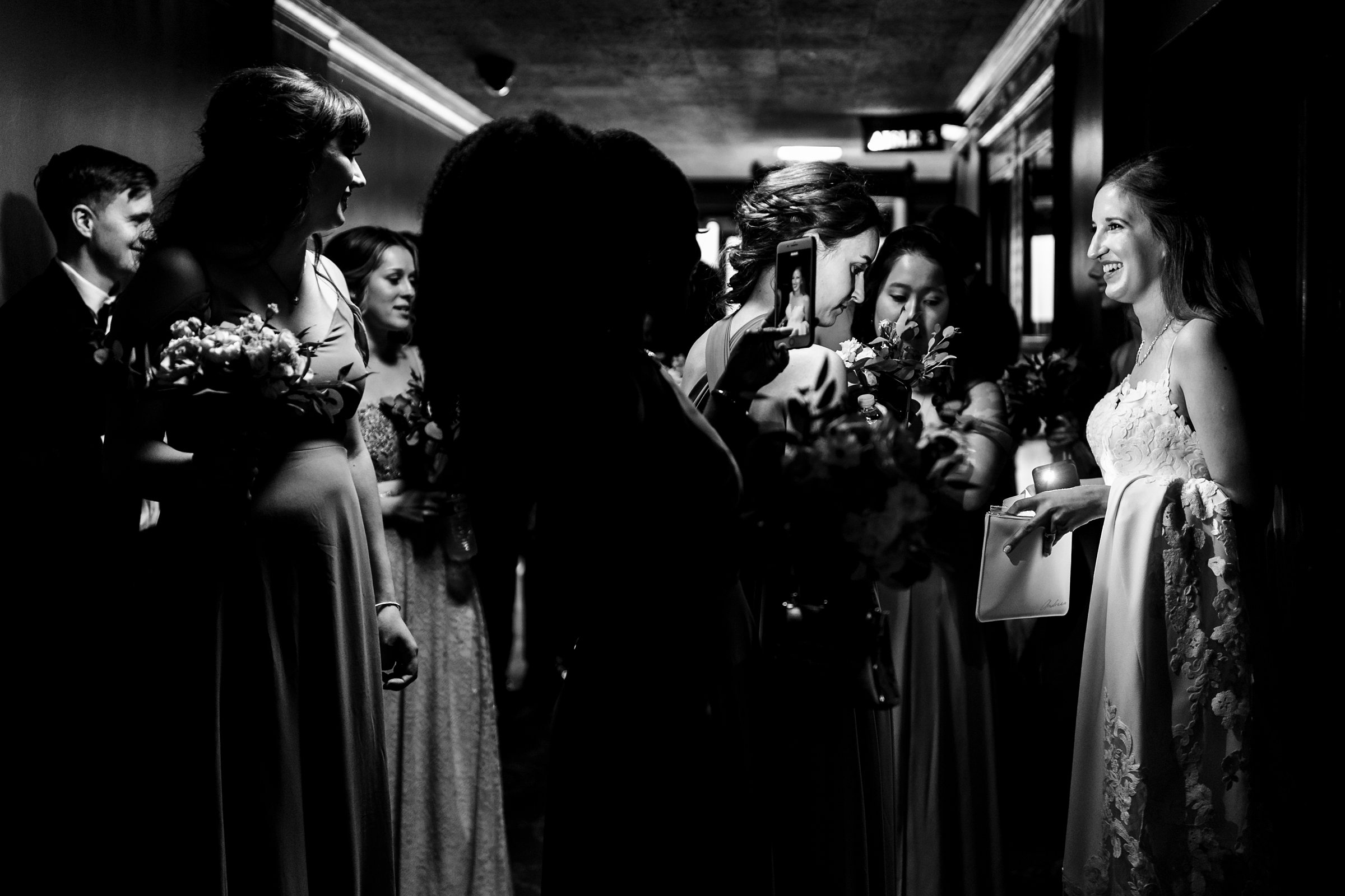 Candid image of the bride and her wedding party getting on the elevator at the  Masonic Temple Wedding in Detroit by Michele Maloney Photography