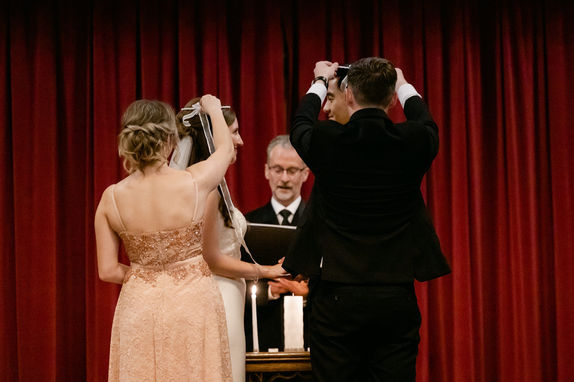Wedding Couple getting crowned during the ceremony at the Masonic Temple in Detroit by Michele Maloney Photography