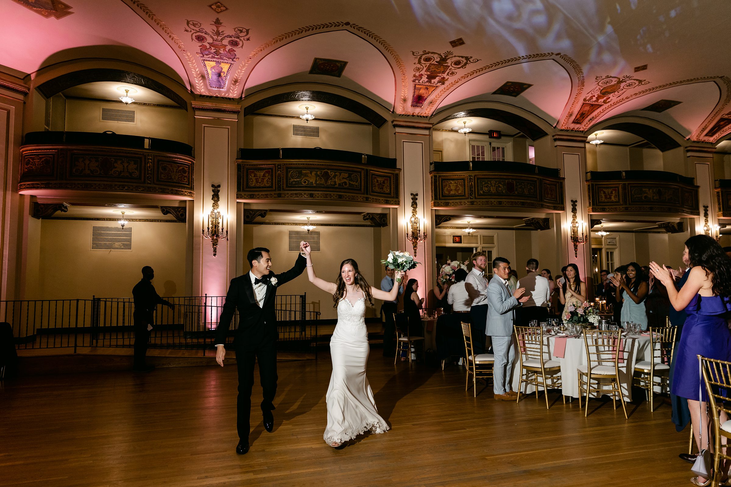 Bride and groom entering the ballroom at the Masonic Temple in Detroit by Michele Maloney Photography