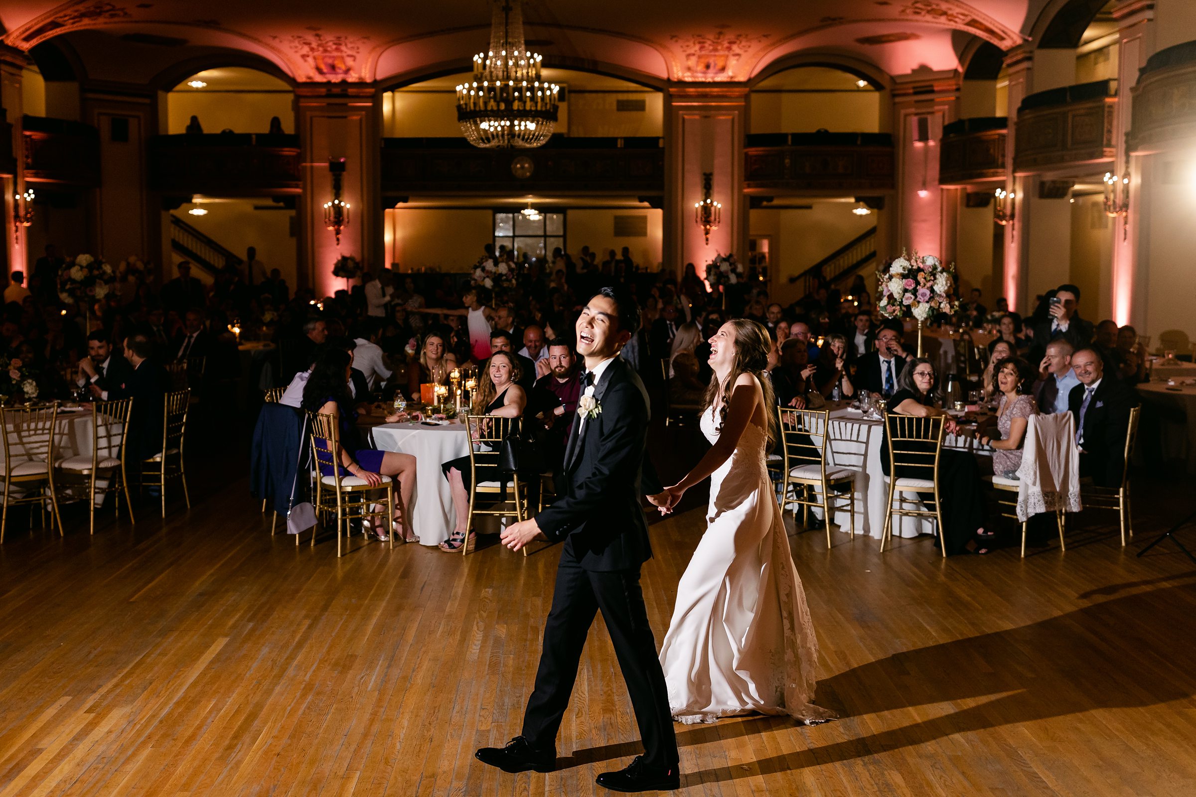 Bride and groom laughing on the dance floor at the Masonic Temple in Detroit by Michele Maloney Photography