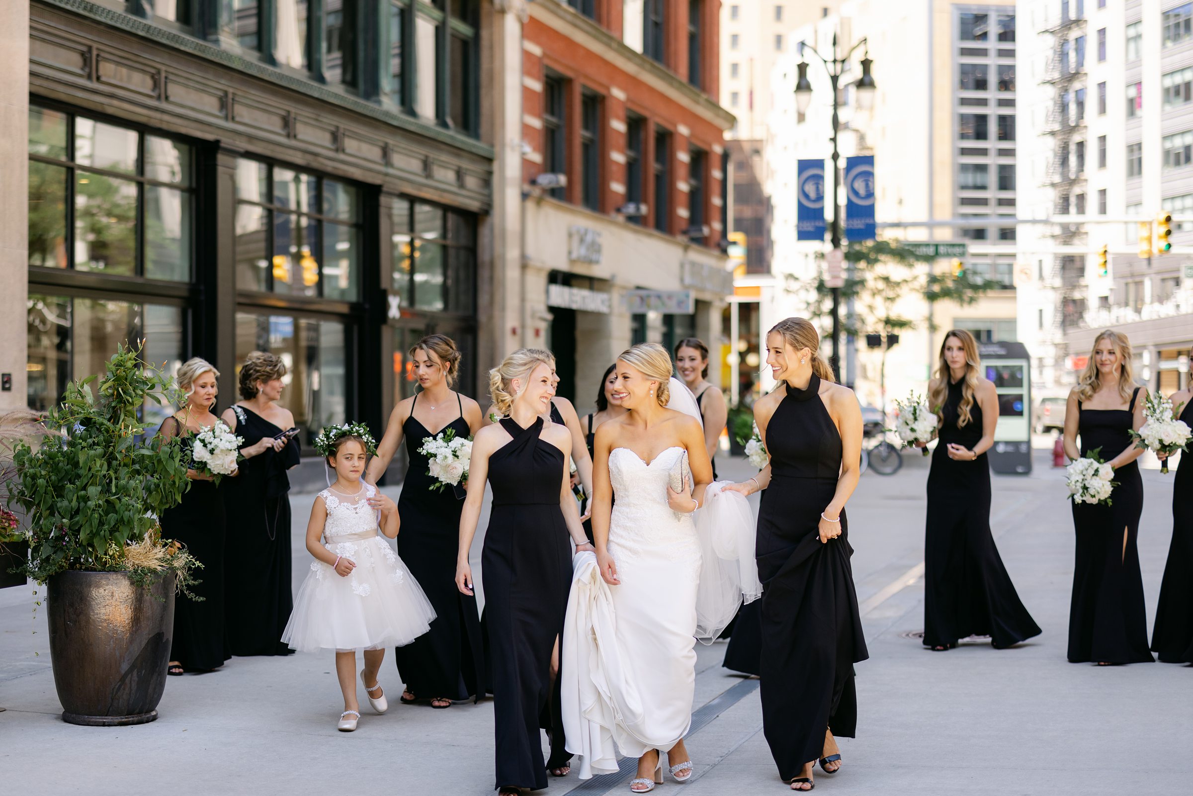 bride walks with bridesmaids through metro Detroit to wedding ceremony