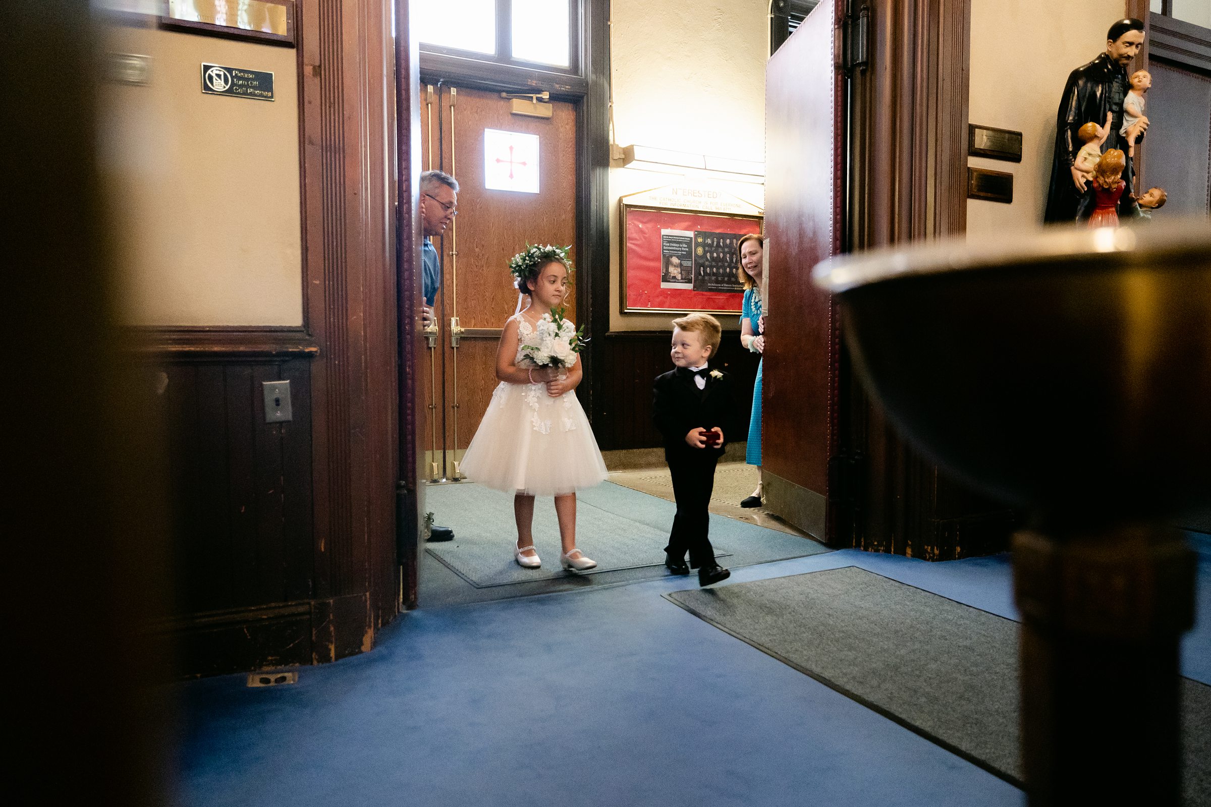 Children walking down the aisle at cathedral wedding ceremony