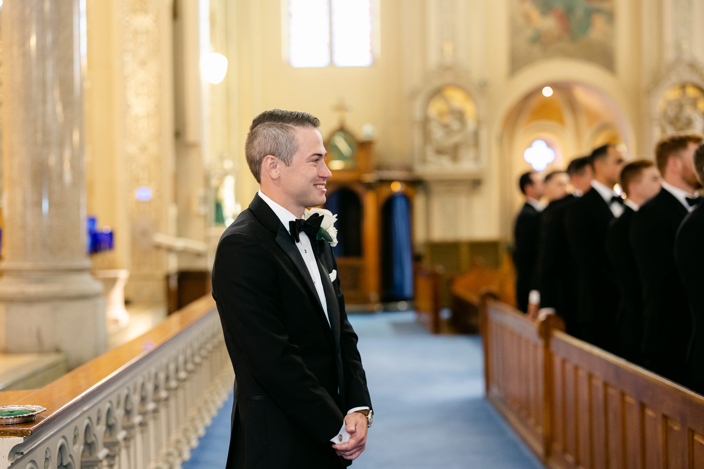 Groom tearing up as he sees his bride walk down the aisle at Old St Mary's In Detroit by Michele Maloney Photography